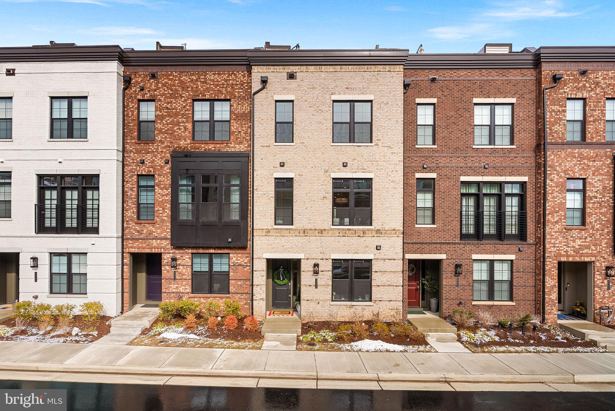 Welcome to this beautifully upgraded, nearly new 4-story townhouse in the highly desirable Metro Walk at Moorefield Station community, just a short walk to the Ashburn Metro Station. Built approximately 1.5 years ago, this exceptional residence offers 4 bedrooms, 3 full baths, and 2 half baths across four thoughtfully designed levels.

The home features light-colored wide plank LVP flooring throughout, creating a bright and cohesive modern aesthetic. The gourmet kitchen opens seamlessly to the main living and dining areas and includes a large center quartz island, ideal for entertaining. Custom wood accent walls and professionally designed closets add distinctive style and functionality.

The spacious primary suite offers a luxurious en-suite bath complete with a large seamless glass walk-in shower and double sink vanity. Additional highlights include motorized blinds throughout, a covered balcony, and an expansive rooftop terrace providing outstanding outdoor living space.

Enjoy walking to everyday conveniences, along with minutes to major commuting routes/international airport for added accessibility. Residents of Metro Walk enjoy access to the community clubhouse, fitness center, and pool, enhancing the lifestyle this home provides.