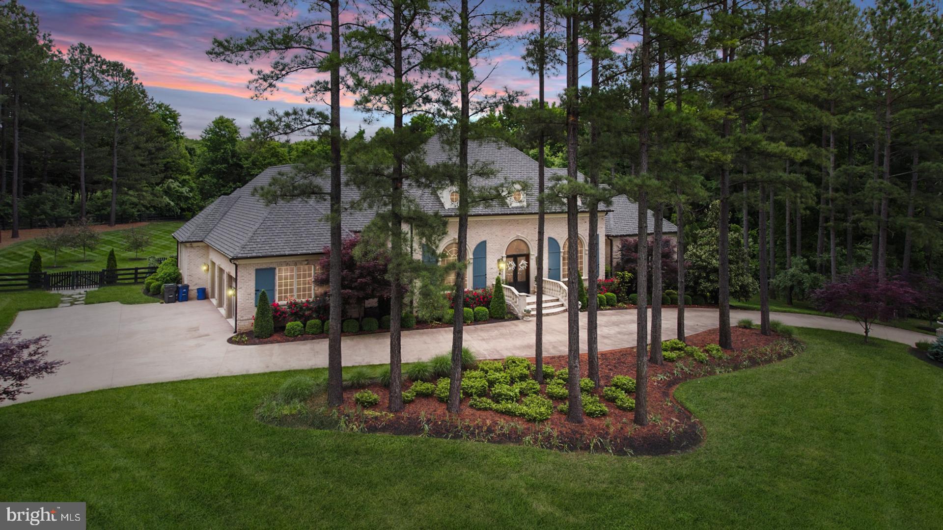 This magnificent French-Provincial estate is a truly a home like no other! Built by luxury home builder, Apex Custom Homes, and situated on a private three-acre lot surrounded by mature trees, this home blends sophistication and elegance throughout. Every detail in this home has been thoughtfully considered - from the hand-scraped hardwood and marble floors that flow underfoot, to the exquisite moldings, archways and chandeliers throughout, this home is full of beauty and style. Entering through the grand Foyer on the main level you’ll discover an elegant and well-designed floor plan. The Great Room welcomes you with soaring ceilings and a cozy fireplace. An impressive gourmet chef’s Kitchen with a 6-burner gas stove and griddle, two sub-zero fridges, two dishwashers, a walk-in pantry and a 10.5’ marble-top island with seating. The Morning Room with beamed ceilings adds to the floor plan and has gorgeous French doors that seamlessly flow out to the hearth terrace with a fireplace.  There is a stunning formal Dining Room, two modern and main level Home Offices, a Keeping Room with beamed ceilings, a wet bar and beverage fridge, and a Mud Room off of the three-car garage, which is the perfect "drop zone" for coming and going. Highly desired main level luxurious Primary Bedroom enjoys his-and-hers closets with custom-built shelving systems, an En Suite Spa-bath with a steam shower, double vanity and a stand-alone soaking tub, plus a Sitting Room with a fireplace and French doors that access the Hearth Terrace on the rear of the home. Three additional spacious bedrooms on the main level, each with a walk-in closet and a private full bath, complete this main level. The spacious lower level of the home boasts a Rec Room and Game Room with multiple seating areas and a wet bar that is perfect for entertaining guests while watching the biggest games each weekend.  Also located on the lower level is an intimate wine tasting room and wine cellar holding 300+ bottles, a Home Gym, and a fifth bedroom with an EnSuite and private entry from the side yard. Find peaceful retreat in the resort-style backyard, which boasts extensive landscaping, lighting, a pool with swim spa and hot tub, a covered pavilion - the perfect outside living space to place to host your family and friends as it boasts a wet bar with marine-grade cabinetry, leathered granite countertops, multiple beverage fridges, and a stone gas fireplace. Creighton Farms is one of greater Washington DCâ€™s most extraordinary, exclusive private club communities. The crown jewel at Creighton Farms is the 18-hole Jack Nicklaus championship golf course. Unparalleled resort style amenities include a brand-new state of the art golf facility with heated indoor bays, two Har-Tru & two USTA hard-surface tennis courts, fitness & wellness facilities, a resort style pool and an elegant Club House offering indoor & al-fresco dining, overnight club rooms for members and guests, Board Room, Library, Golf Shop & more.