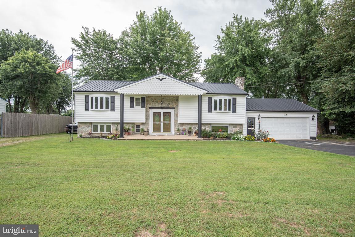 This very well-maintained home is located just minutes from US rt-1. This home has new windows, siding, gutters, and metal roof. with 5 bedrooms and 2 full baths, this property offers you a lot of opportunities for either personal or professional use. There is a large great room on the upper level and a cozy living room on the lower level with a beautiful fireplace. The attached (heated) garage has plenty of built-in shelving for storage. This property is in a C2 commercial zone that is intended for retail commercial uses. There is a large shop on the property that has its own parking lot and drive way. It includes a car lift an air compressor and 2 space heaters as well as some tools. There are 3 large garage doors (one is 12' x 12', and two are 10' x 10). The concrete floors have drains for easy cleaning. There is plenty of room for customer parking.
