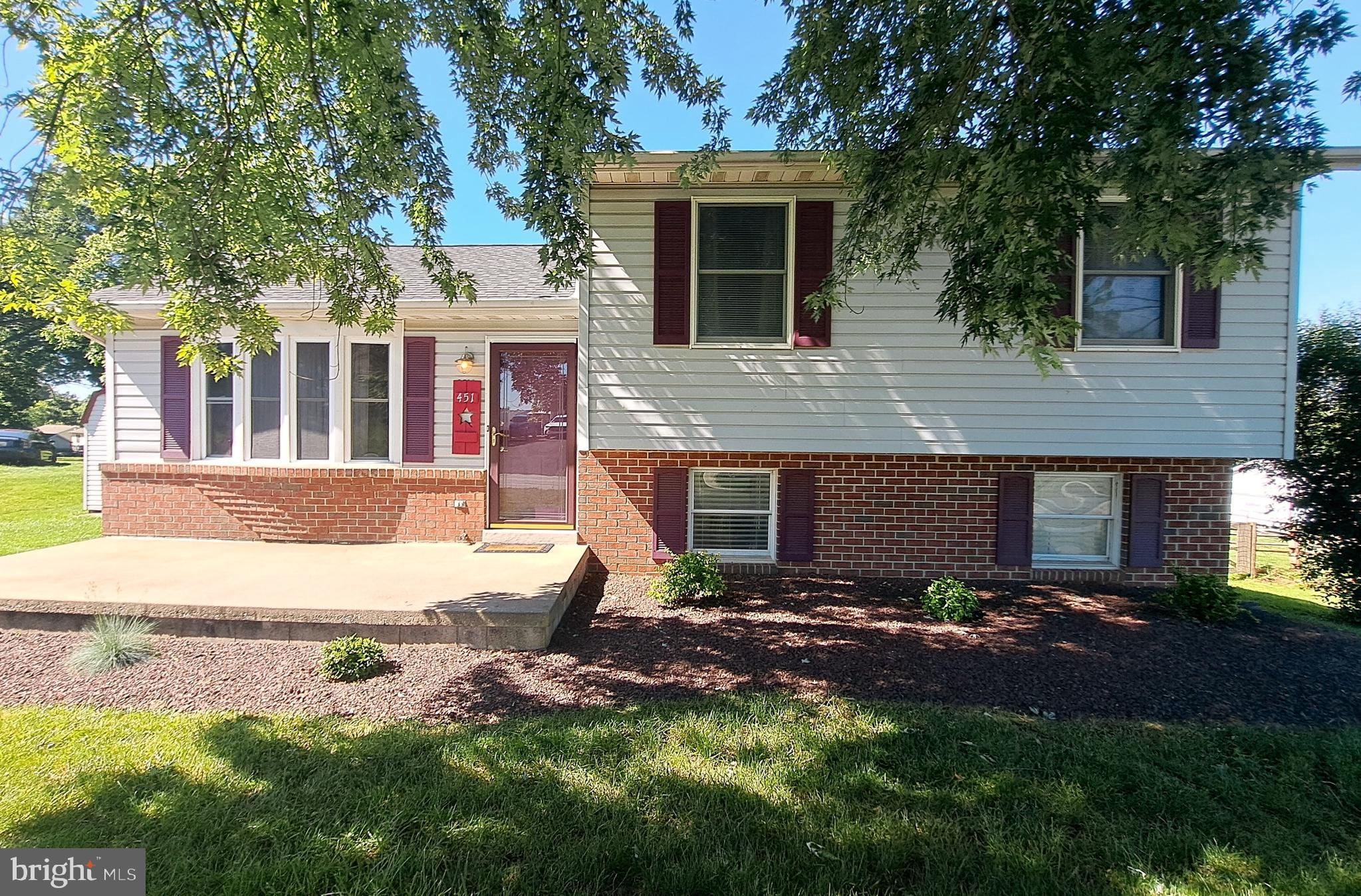 *Open House Saturday, June 6 from 12pm-2pm* This home with its recent updates could easily become your forever home. It boasts four bedrooms and three full baths. The entire lower level #1 consists entirely of a huge primary bedroom with ensuite bathroom and walk-in closet. The top floor consists of three bedrooms - one with an ensuite bathroom. The main floor contains a large family room, kitchen with plenty of cabinet and counter space, and an ample dining area. The unfinished basement has plenty of room for storage and is where all of the utilities are located, including the washer/dryer hookup. This south-facing home has plenty of outdoor sitting areas - a front porch, a deck off of the dining area, or the rear patio accessed from the primary bedroom.  Large back yard with plenty of grass. The driveway comfortably fits four vehicles, and on-street parking means this home will be perfect for hosting family gatherings and cookouts with friends. Roof was replaced in 2022 and the primary bedroom was added in 2023. A home with all of these features will not last long!