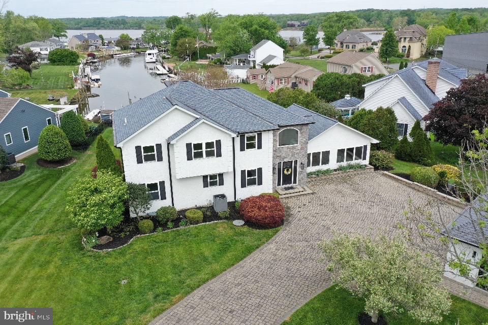 Tucked into the Harbours community of North East, this home offers 3 levels of living, 4 bedrooms, and 3 full bathrooms — plenty of room for family, guests, or however you choose to use it. Situated directly on a sheltered canal with easy access to the Chesapeake Bay, large windows on every level frame the water and fill the home with natural light. The grand room is open and well-proportioned, with views of the canal that make it a comfortable space for entertaining or everyday living. Multiple balconies and porches extend your living space outdoors, each offering a slightly different perspective of the water — and the sunsets this stretch of the Bay is known for. Out back, a private floating dock accommodates a boat, personal watercraft, and kayaks, with calm, protected water year-round. A hot tub on the rear porch completes the outdoor living. When you're ready to venture out, the Nauti Goose, Woody's Crab House, and other local favorites are just minutes away.