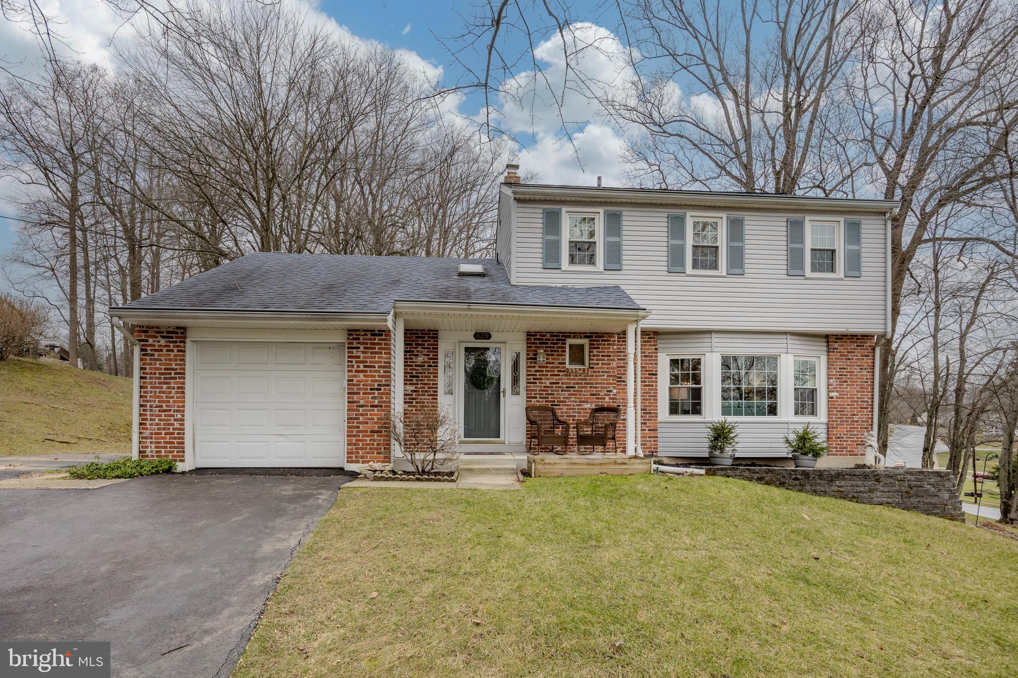 Welcome to this charming 3 Bedroom, 2.5 Bath Colonial in the popular Sidewalk Community of Marchwood! In addition to the highly sought-after Downingtown East School District with STEM Academy, this home’s prime location is only minutes from parks, schools, major routes, restaurants, and shopping! A covered front porch welcomes you as you enter this warm and inviting home that has been well-maintained over the past 45 years. The main level presents a 2-story foyer with a turned staircase, skylight and hardwood flooring, updated powder room, spacious living room with picture window and carpeting over hardwood floors, formal dining room with carpeting over hardwood floors and kitchen with eating area, ceiling fan, new ss dishwasher, and double window overlooking the private rear yard. The adjoining family room features a brick wall with wood fireplace, ceiling fan, alcove with seating bar and lighting (potential for creating laundry or storage closet OR desk/homework area), exit to the garage with opener and shelving, and a sliding glass door leading to the deck with gate. The rear yard includes a newer shed (2017) that’s handy for storing lawn and play equipment. Upstairs, the primary bedroom features a closet with organizer, carpeting over hardwood floors, and ceiling fan. Two additional bedrooms have hardwood floors, and one has a ceiling fan. The updated hall Bathroom offers a double-bowl vanity and tub enclosure. Heading down to the Basement, you’ll find a newer bathroom with shower, laundry facilities and lots of convenient shelving units. There's plenty of room to create additional living space or to use for storage, working out or for your hobbies. Updates include extension on driveway for additional parking space (2018), front porch, hot water heater (2021), washer and dryer (2021),  central air system (2017), sliding glass door (2019), various rooms freshly painted, electrical/lighting upgrades, replacement windows, front door, and vinyl siding.  Put your personal touches on this well-cared for home and come enjoy everything that this amazing neighborhood has to offer!