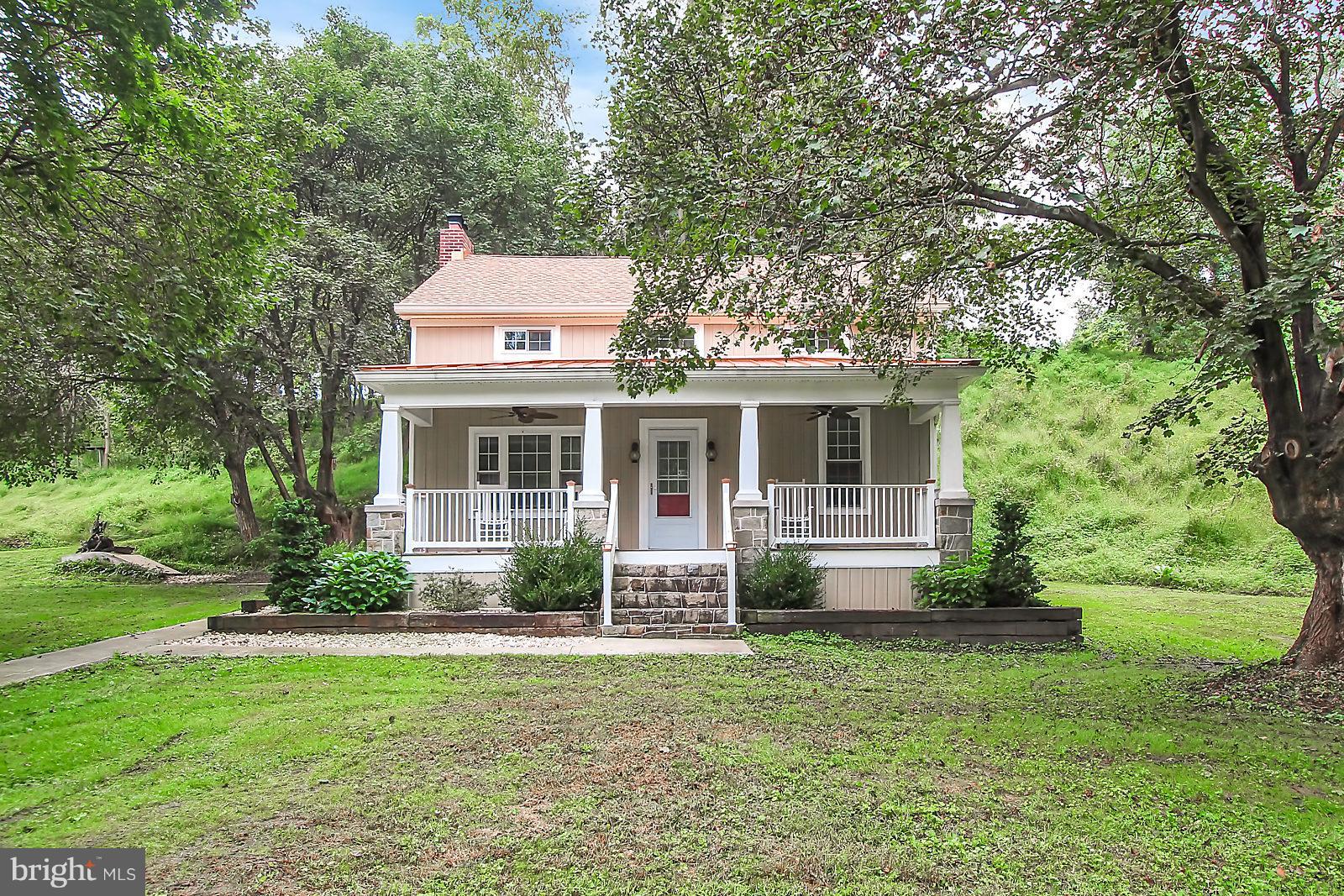 Horse lovers dream! This 32 acre property includes updated farm house, 3 barns, tack shop, 20+ horse stall barn that leads to a riding area with 5 acre pasture and babbling stream. The 4 bedroom,  3 bath home has a large welcoming covered front porch, bamboo flooring throughout, updated bathrooms, recently renovated kitchen with new cabinets, granite counters and stainless steel appliances. Call today for a tour of this beautiful property!