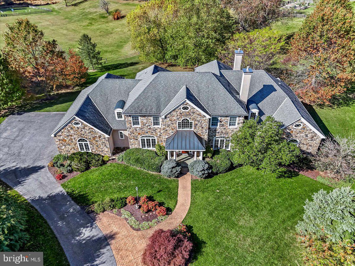 Timing is everything and your time is now! Thoughtfully designed for both grand entertaining and everyday comfort, this home blends timeless architecture with modern elegance. Enter through the stately front door and into a light-filled two-story foyer with a majestic turned staircase that opens to expansive formal and casual living spaces. The main level features a formal living room with a fireplace, private office with a fireplace, and a beautiful dining room designed for memorable gatherings. The open-concept family room with a fireplace, breakfast area, and chef’s kitchen are the heart of the home, complete with top-of-the-line appliances, an expansive island, and a walk-in pantry.  Seamless indoor-outdoor flow invites you to the resort-style landscape that is your own backyard!  And it is accessible directly from the main floor—a perfect extension of your living space for effortless entertaining.  Set against a lush and open backdrop, the property’s outdoor living spaces are a daily delight. Afternoons can be spent lounging in dappled shade of the backyard, mornings on the back porch with coffee and birdsong, and evenings entertaining under the stars. The expansive lawn offers a perfect playground—whether for children, pets, or simply enjoying the tranquility of nature.  The sumptuous primary suite is a true retreat!  With a fireplace and sitting area and huge walk-in closets, it is both gracious and intimate! The primary bath is stupendous with double sinks, make-up seating area, extremely large walk-in shower, his-and-her closets and soaking tub.  The formal and informal half baths as well as the large laundry room complete the main floor.  There are four generously proportioned bedrooms en-suite on the second level.  And there is a bonus room/6th bedroom/flex space with a full bath!  The walk-in storage area of the second floor makes life so easy for retrieving those items you only need a few times a year! Every space in this home has been thoughtfully designed.  Beyond the boundaries of this home lie a surrounding community and connections to local parks and businesses.  Within a short drive, one can dine in many of the wonderful restaurants in the West Chester Borough or enjoy a nature walk in Brinton Run Preserve or the Brandywine Battlefield. Known for the area’s top-rated public schools—Chadds Ford Elementary, Patton Middle, and Unionville High School—and close to an array of distinguished private schools, this location is unmatched in its blend of education, community, and convenience. This residence is more than just a home - it's a statement of craftsmanship, livability and timeless design. A property of this caliber, with such an uncompromising level of finish, simply cannot be recreated in today's market at this price. Don't miss this rare opportunity to own a home that enchants, inspires, and elevates your everyday living - make it yours today!