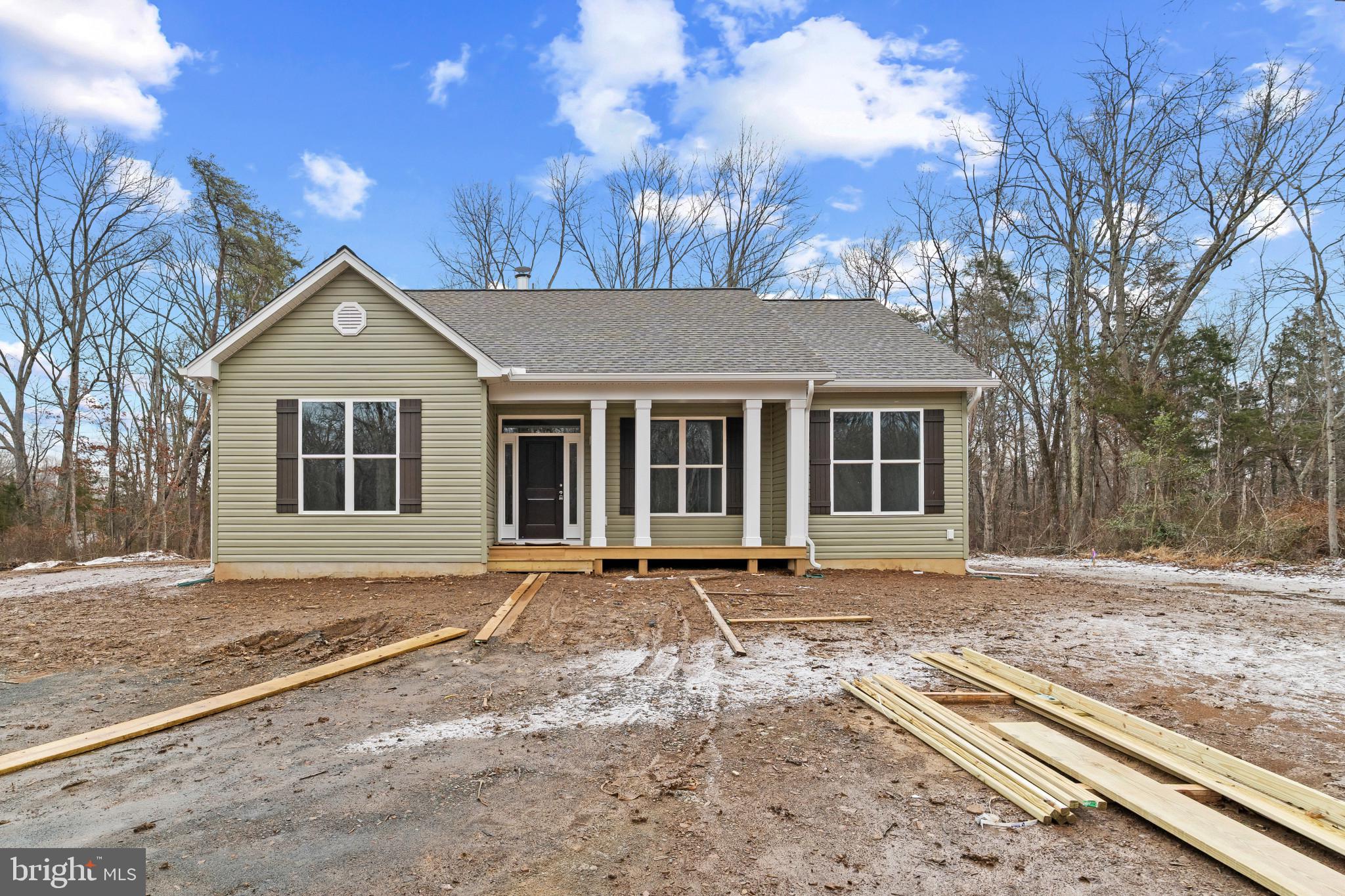 Price improvement—motivated seller! This stunning new construction home is complete and ready for showings! Situated on more than 5 beautiful acres, enjoy peaceful surroundings and breathtaking natural views right from your doorstep.
Step inside to a dramatic floor-to-ceiling stone fireplace,  perfect for cozy evenings by the wood-burning fire. The main living areas feature gorgeous plank wood flooring, while the bedrooms offer brand-new plush carpeting for added comfort.
The kitchen and laundry come fully equipped with all-new appliances, including a refrigerator, oven, microwave, garbage disposal, washer, and dryer ,  move-in ready with modern convenience in mind.
Outside, the property has been cleared and leveled, creating the ideal setting for a future barn, garage, or additional outdoor living space. Final exterior enhancements, including yard seeding, driveway leveling with a finished top layer, and a stunning stone walkway leading to the front porch are now complete. These finishing touches will make this exceptional home even more turnkey.