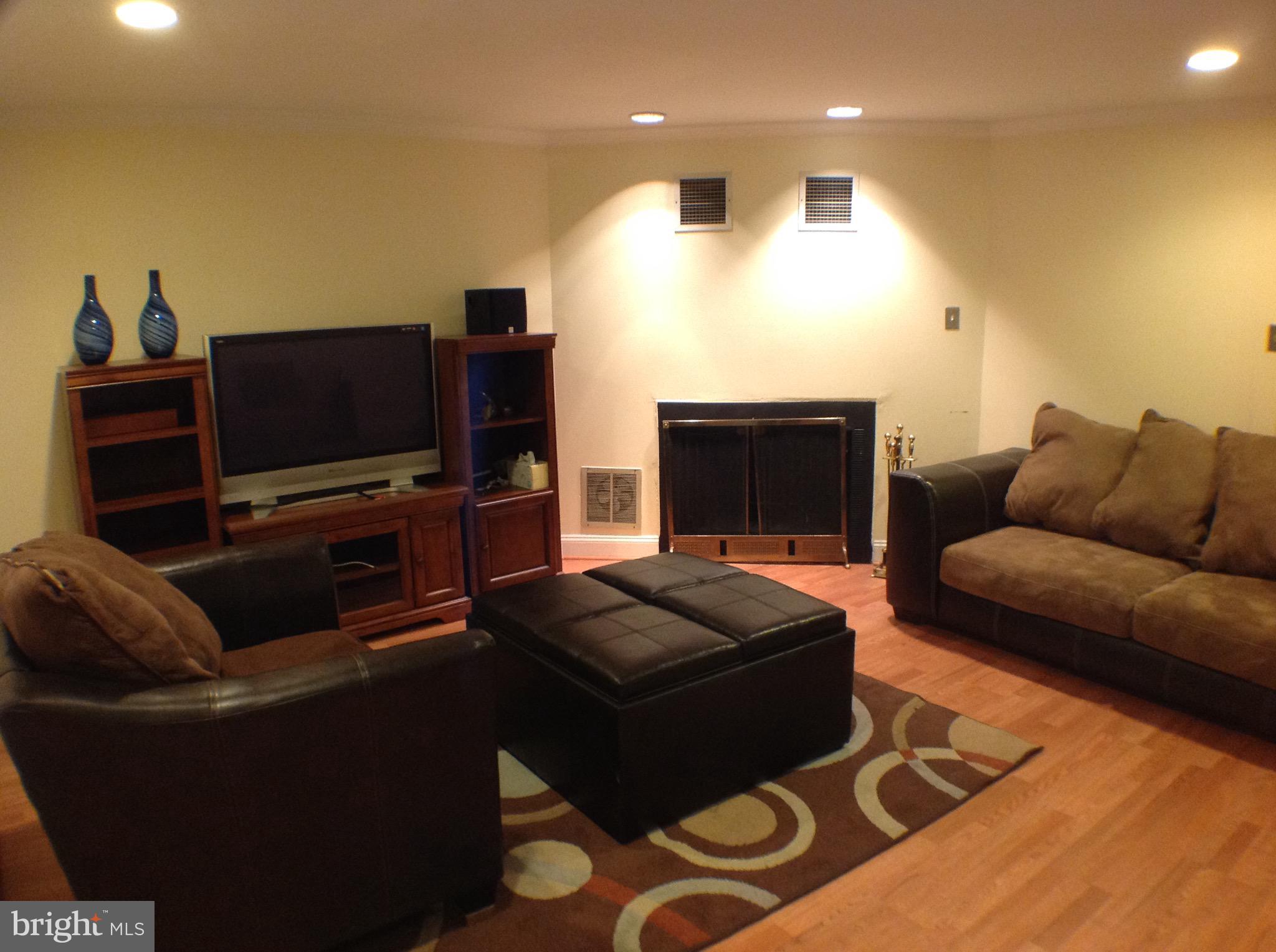 Very nice renovated interior townhouse w 3 beds up and 2 full baths. Main w large liv rm, dining room and table space kitchen w half bath.  Pergo on main and lower lvl.  Lower level w legal bedroom, fireplace, and walk out to nicely finished patio and fenced yard. All ready to move in. Security cameras front and rear convey as well as doorbell cam and NEST thermometer. Close to everything!!