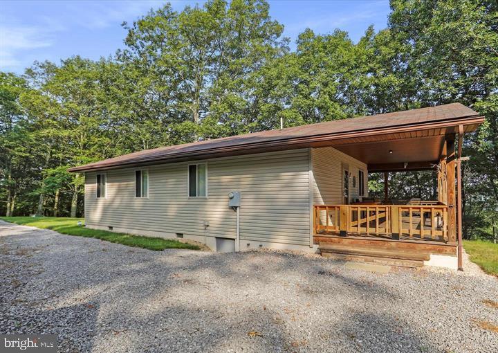 Own the Mountain - 22.22 Acres with Cabin, Big Views, and a Major Comfort Upgrade. This is the one buyers look for and rarely find. 22.22 acres of high-elevation West Virginia mountain ground, rising over 2,000 feet above sea level with commanding views over Corridor H and the surrounding valleys. Fully wooded with mature hardwoods, quiet, private, and loaded with deer, bear, and turkey, this property delivers the kind of outdoor experience people imagine when they start searching for a true mountain retreat. The cabin is clean, solid, and ready to enjoy. It offers three true bedrooms, one full bath, hardwood floors, a dependable wood stove, and a wraparound porch that puts you right in the middle of the setting. Even better, the owners have recently installed a brand-new mini-split heating and cooling system, giving the cabin year-round comfort and a significant upgrade over the prior setup. Whether you are coming for weekends, hunting season, summer escapes, or longer stays, this property is far more usable and comfortable than the typical mountain cabin. The land adds even more appeal. A pond on the property, a solid outbuilding for gear, tools, or toys, and plenty of room to hunt, ride, hike, or simply disappear into the quiet. The setting feels remote, but access is refreshingly easy. No endless rough trails or punishing switchbacks. Just turn off Corridor H and you are on the property in minutes. Total privacy, big views, and mountain seclusion, all while being only about 15 minutes from Moorefield. Recreation is all around you. The South Branch of the Potomac River is nearby, and the George Washington National Forest offers thousands of acres to hunt, fish, hike, and explore. For buyers coming from Northern Virginia, Maryland, or the D.C. region, this is an easy escape with the kind of privacy and freedom that keeps getting harder to find. This is not a wish-list project or a bare-bones camp. It is a well-built cabin, honest mountain land, strong access, big views, and now, upgraded heating and cooling for year-round use. If you have been waiting for a true West Virginia retreat that is ready to enjoy from day one, this one deserves your attention.