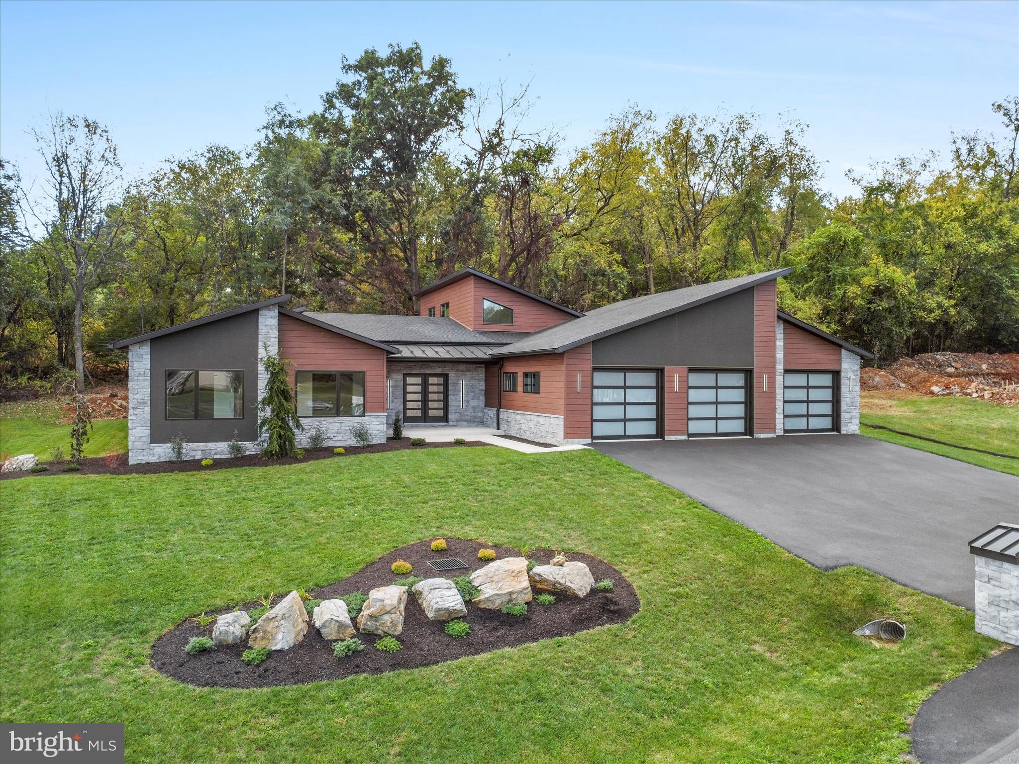 Welcome to 1868 Carrera Drive, a luxury home in the neighborhood of Falling Spring Estates, Chambersburg.  This upgraded ranch home features an open floor plan with high ceilings and large windows that flood natural light illuminating the rich Brazilian Oak engineered hardwood floors and dramatic propane stone fireplace extending from floor-to-ceiling.  A state-of-the-art chef's kitchen with beautiful Timberlake cabinets, quartz countertops, double wall ovens and gas Jenn-Air cooktop.  A walk-in custom pantry with maple shelving for ample storage. The grand front double door entry way and wide hallway lead to the Primary Bedroom and Bath for a spa-like experience with a tile walk-in shower. Double pocket doors lead to a custom maple shelving and displaying apparel racks with a beautiful crystal chandelier to light up the center island.  The heated 4 car garage has it's own full bath and washer/dryer area and an EV charger.  The property is surrounded by lush landscaping.  This is an entertainers paradise with covered patio that offers a TV mount to view your favorite programs while experiencing privacy and tranquility while still being a short drive to shopping and dining.  This new home is well built and one of a kind. This is not just a house; it's a lifestyle! Call today for a showing, you won't be disappointed!
