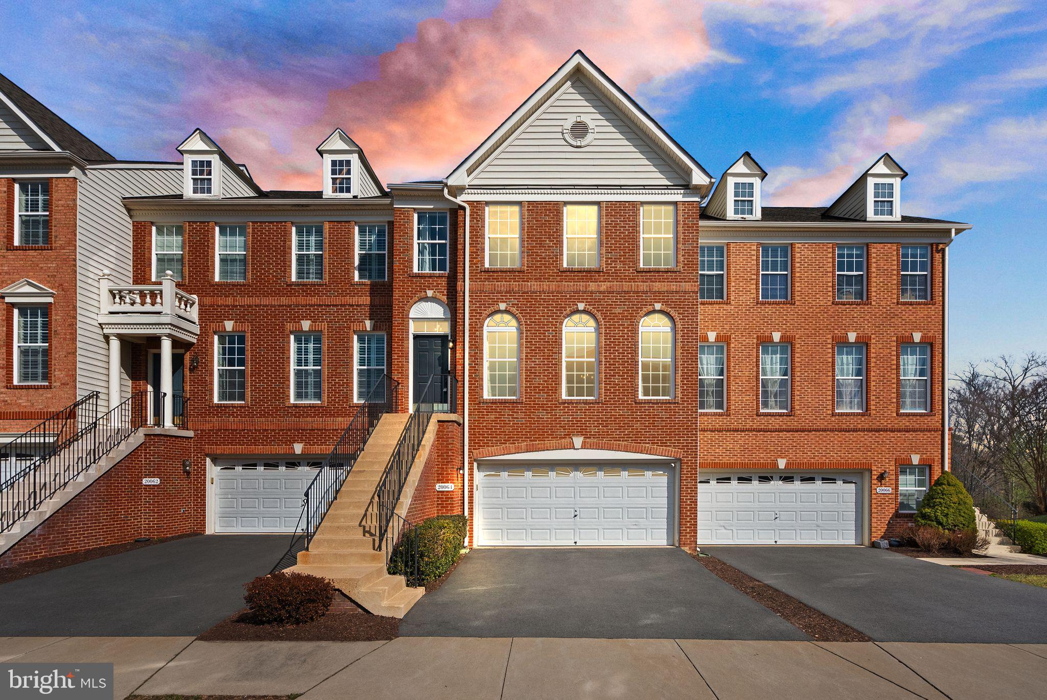 Open House Saturday, March 23rd 2-4pm and Sunday, March 24th 2-4pm. **Experience the luxury of privacy, thoughtful upgrades, and effortless indoor-outdoor living in this beautiful townhome backing to mature trees in Belmont Country Club. Beyond the entry gates of this exclusive community, the three-level property welcomes with a stately brick facade and two-car garage. Inside, the open-concept main level is designed for easy entertaining, featuring hardwood floors, high ceilings, crown moldings, and a gourmet kitchen equipped with stainless appliances and dark wood cabinetry. Upstairs, three bedrooms with newly installed bamboo flooring provide peaceful seclusion from the living areas. The impressive primary suite includes double closets and a spacious bath with dual sinks, glass-enclosed shower, and jacuzzi tub beneath an overhead skylight. The daylight walk-out basement adds flexible living space perfect for a home gym, office, or casual recreation area. With a full bath already in place, this space could also be converted to a private guest suite. Recent interior updates enhance your everyday comfort: an upgraded guest bath, updated laundry room, durable LVP wood-like flooring and neutral paint in the basement, as well as custom closet systems in each bedroom. Outdoor spaces extend the home's versatility. Enjoy the large TREX deck overlooking lush landscaping or relax on the covered paver patio below. The spacious two-car garage adds convenience and extra storage. Located within Belmont Country Club, residents have access to exceptional amenities anchored by an Arnold Palmer-designed 18-hole golf course and a 35,000 sq ft clubhouse inspired by historic Virginia architecture. Community features include multiple pools, tennis and basketball courts, playgrounds, fitness center with workout studios, clubhouse dining options, walking trails, and more. Shopping centers, diverse dining options, recreation spots, and local conveniences are all within easy reach. Offering privacy, style, and versatile living spaces within a premier golf course community, this home unlocks a sought-after lifestyle.