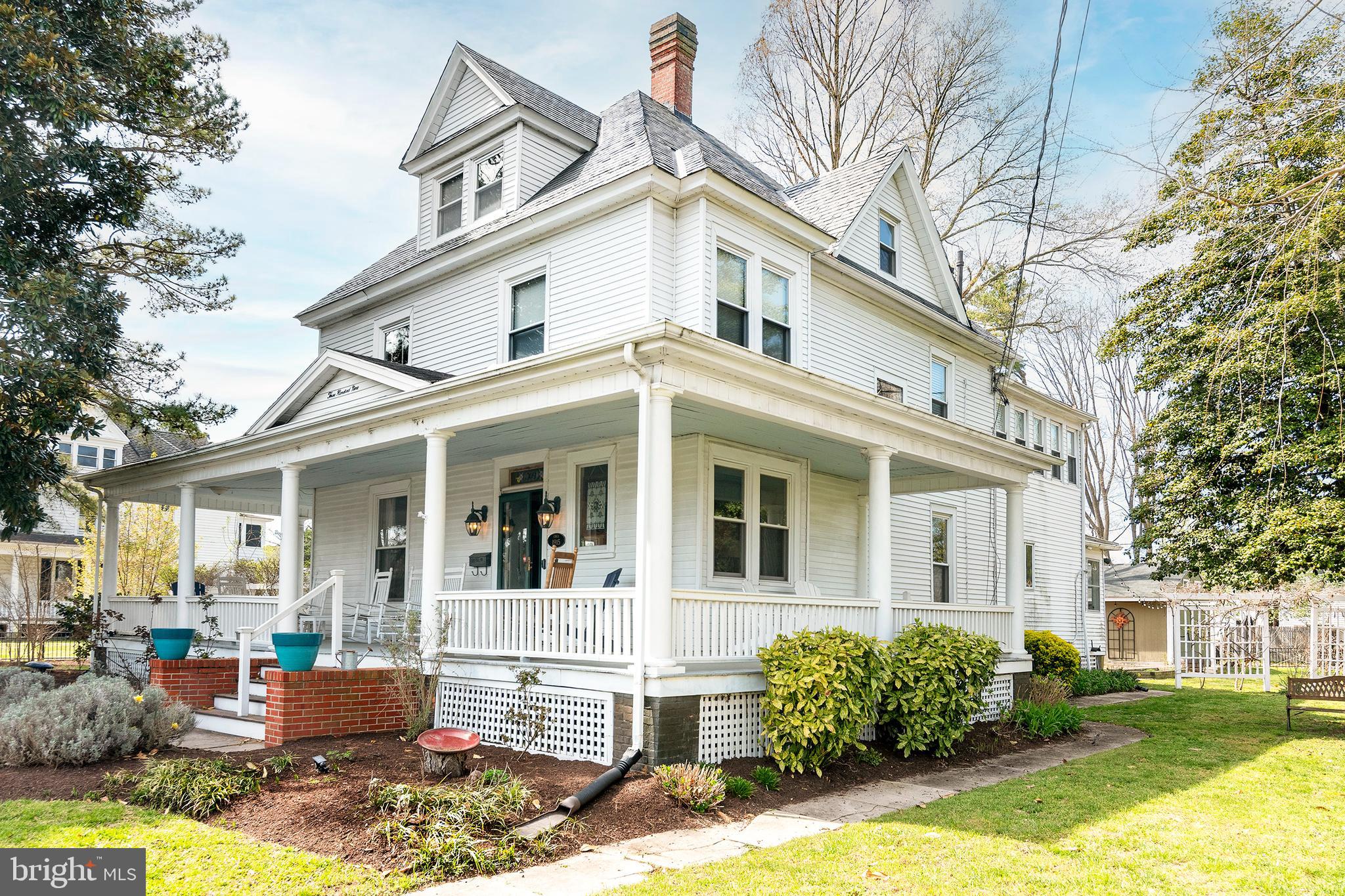 This is a beautifully updated and well-maintained Four Square located in Cambridge's Historic District. It is a grand house for entertaining both inside and out. In addition to the 5 bedrooms and 3.5 baths in the Manor House, the property boasts 2 additional buildings on the .57 acre lot filled with specimen flowers, shrubs and trees. 1 building, originally built as a Montessori school, is well suited as a studio, in-law suite, professional office space or Man cave.  It is currently registered and generating income as an Airbnb.