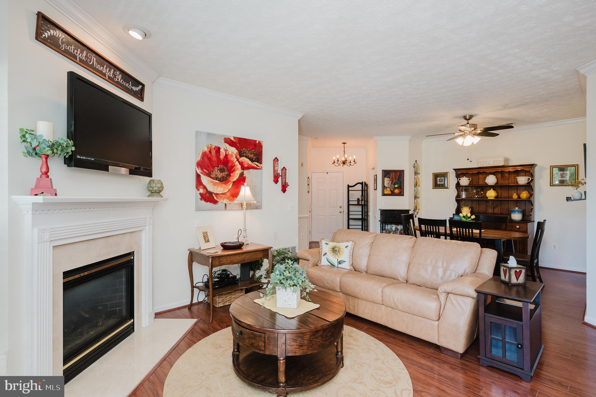 Welcome to 4928 Brightleaf Ct. #4928 in the desirable Devonshire at White Marsh community! This beautifully updated elevator condo offers convenient one-level living with 3 bedrooms, 2 full baths, and approximately 1,331 square feet. The open floor plan features a spacious living room with a gas fireplace and access to a private balcony with storage, a separate dining area, and a bright kitchen with table space, pantry, and ample cabinetry. The primary suite includes a walk-in closet and private bath. Recent updates include replacement windows (2017), HVAC (2020), water heater (2018), fresh paint, and new carpet. Additional features include recessed lighting, crown molding, chair rail, in-unit laundry, and assigned parking. The elevator building provides easy access, and the condo association covers common area maintenance, exterior maintenance, lawn care, snow removal, trash, and more. Conveniently located near shopping, dining, parks, White Marsh Mall, The Avenue at White Marsh, and major commuter routes including I-95 and I-695.