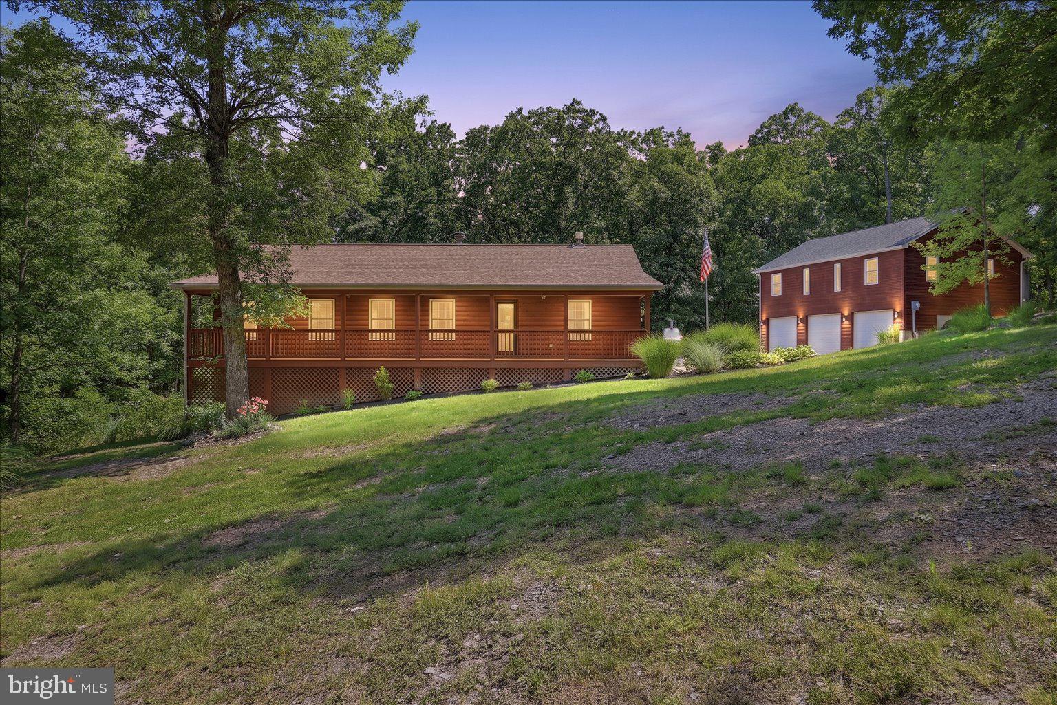 Beautiful property with so much to offer! The main home features fresh paint, refinished hardwood floors, a beautiful etched-glass front door, and a new French door leading to the rear deck. Enjoy the full front porch, perfect for watching wildlife or sharing great conversation. The kitchen offers newer upgraded appliances and a huge deep sink. A split-bedroom design provides privacy and functionality.
The full basement includes a recreation room, workshop with extra ventilation, large laundry/storage area, and half bath. The 3-car garage is exceptionally versatile with expanded 200-amp electric service, four 50-amp welder plugs, and a 30-amp air-compressor plug. Above the garage is a 1-bedroom apartment with its own front porch and vaulted living ceiling.
An outdoor wood/coal-burning furnace adds off-grid appeal. Additional features include 2 HVAC systems, 2 water heaters, 2 water softeners, and 2 generator hookups. Come see this beautiful property and fall in love!