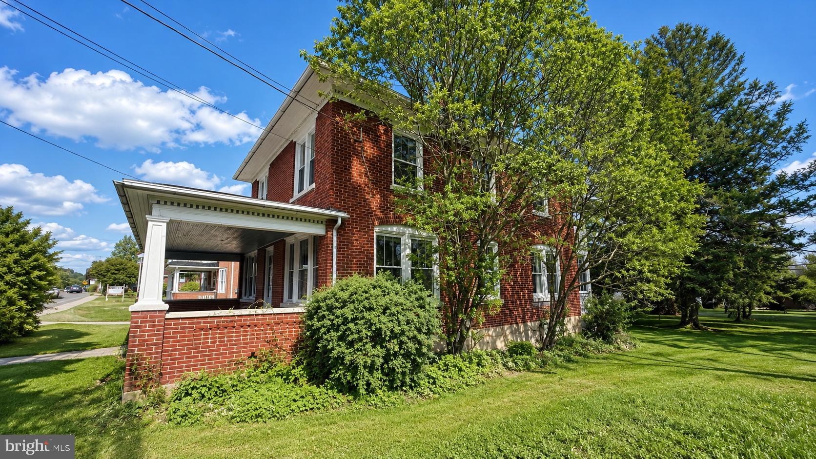 **OPEN HOUSE** Wednesday 5/13 5:30-7 PM Fall in love with this beautifully maintained 1900’s brick home offering over 1,900 square feet of living space, perfectly designed for comfort and everyday living. This inviting property features 3 spacious bedrooms and 2 bathrooms (1 full and 1 half), making it an ideal fit for families or anyone looking for room to grow.

Step inside and enjoy the charm of original maple hardwood floors flowing throughout the downstairs of the home and original pine flooring upstairs. There is a top-of-the-line kitchen that has granite countertops as well as custom made cabinetry. This beautifully upgraded kitchen is both stylish and functional — perfect for cooking, entertaining, and gathering with family and friends.

There are 2 sets of pocket doors downstairs to allow for an open living concept or the ability to separate rooms. There is a new washer and dryer on the first floor as well.

In addition to the living areas there is a full walk-up attic and a full basement.

One of the home’s most charming features is the four covered porches, offering multiple spaces to relax and enjoy the outdoors. Upstairs features two covered porches, including a “sleeping porch” off the master suite, perfect for enjoying quiet mornings or cool summer evenings.

The home has been thoughtfully updated with new windows throughout, bringing in plenty of natural light while improving energy efficiency.

Outside, you’ll find a huge backyard offering endless possibilities for outdoor entertaining, gardening, or simply relaxing in your own private space. The lot on the west side of the home is deeded separately and is included in the current purchase price of the home. The property also includes an oversized garage, providing excellent storage, workspace, or room for multiple vehicles.

Well cared for and move-in ready, this home blends character, modern updates, and generous space both inside and out. Homes offering this much space, charm, and outdoor living rarely come available — schedule your private showing today.