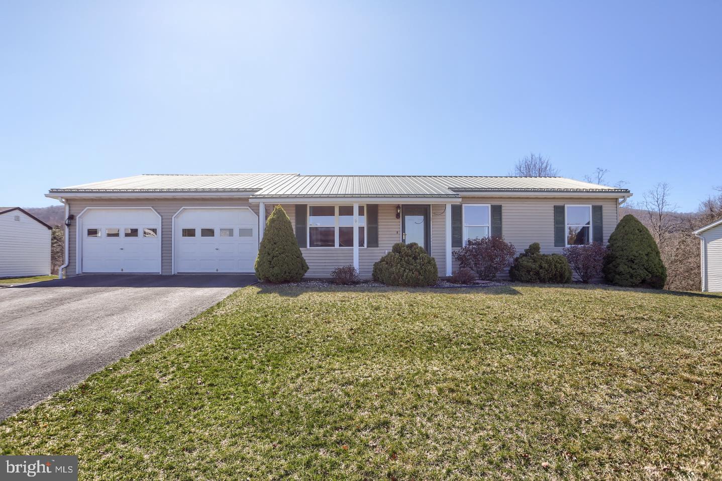 This inviting ranch home is designed for effortless one-level living. With three cozy bedrooms and brand-new bamboo flooring gracing the main level, the home feels fresh and modern. The newly added four-season room off the kitchen is a perfect spot to enjoy a cup of coffee any time of day. Downstairs, the finished walk-out basement not only expands your living space but also features a full bathroom for convenience.

Outside, the extra-deep two-car attached garage—with washer/dryer hookup—offers ample storage, while the maintenance-free vinyl siding and metal roof promise peace of mind. Step into your backyard oasis where trees, especially when in bloom, create a stunning, ever-changing natural canvas. A generous double-wide driveway ensures plenty of parking. Schedule your showing today!