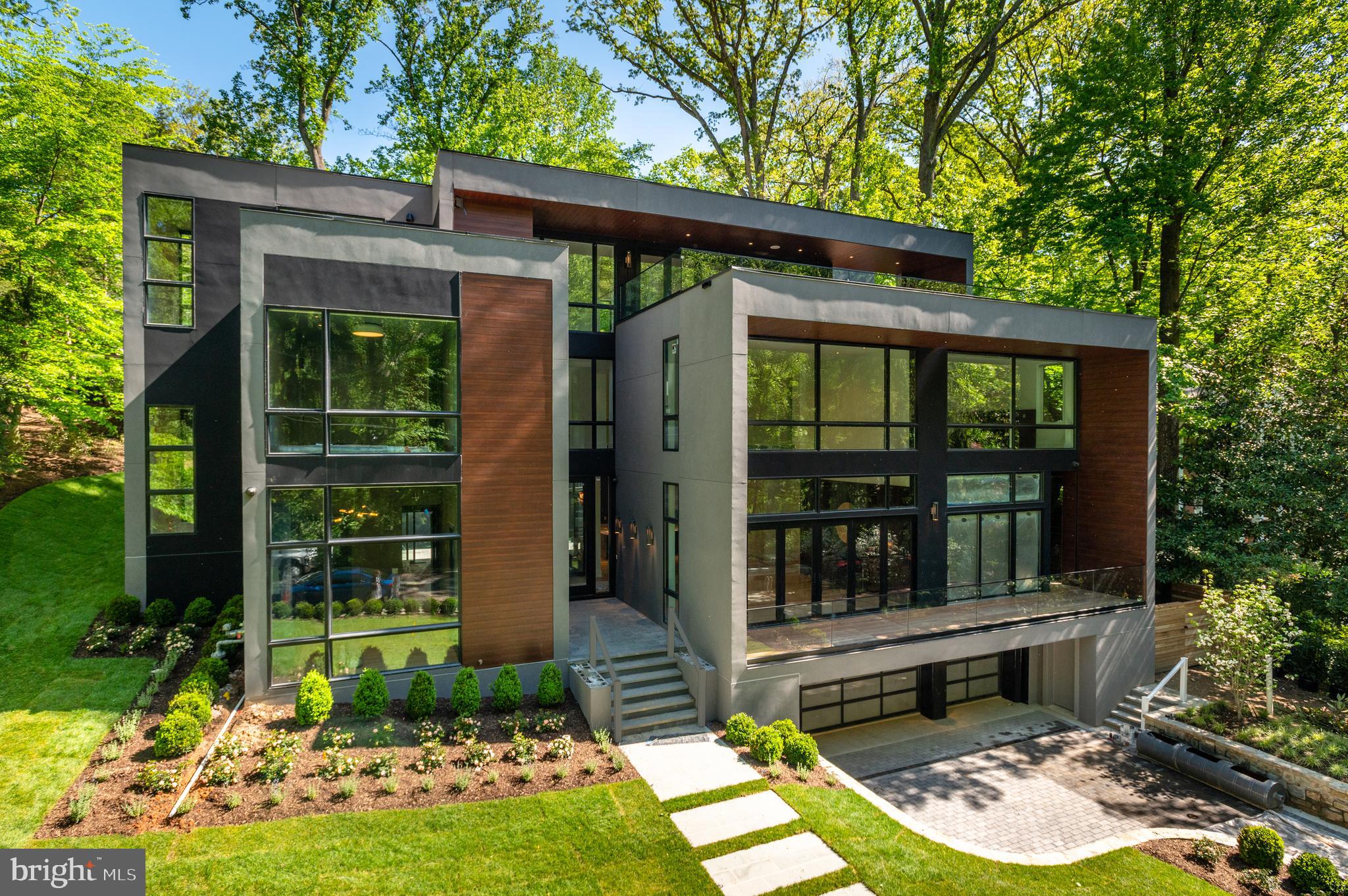 Premier New Construction by Coba Properties! Contemporary 10k+ SF Residence on a private and serene cul-de-sac with unparalleled views of Soapstone Valley directly across the street. Incredible scale with 10'+ ceilings on the Main Level with Custom Designer finishes throughout. The Impressive two-story Family Room with floor-to-ceiling park views opens to the Gourmet Chef's Kitchen with Thermador and Wolf appliances. The main level walks out to the rear patio with Outdoor Kitchen and Swimming Pool. The second level begins with 2 Bedrooms with en suite Baths and continues across a bridge lined with glass panels across to the Primary Suite with park views and a lux Primary Bath with walk-in shower, soaking tub, and 2 vanities; as well as a spacious walk-in closet. The Third Level includes a 3rd Bedroom with en suite Bath and private Roofdeck; and a Recreation Room with Kitchenette that walks out through nano glass doors to the roof deck with 180-degree views! The Lower Level includes a 2nd Recreation Room with Kitchenette, Fitness Room, Bedroom with en suite Bath, Laundry Room with pet shower, and a Mudroom that leads to the 3-car Garage. There is an elevator that services all levels.
