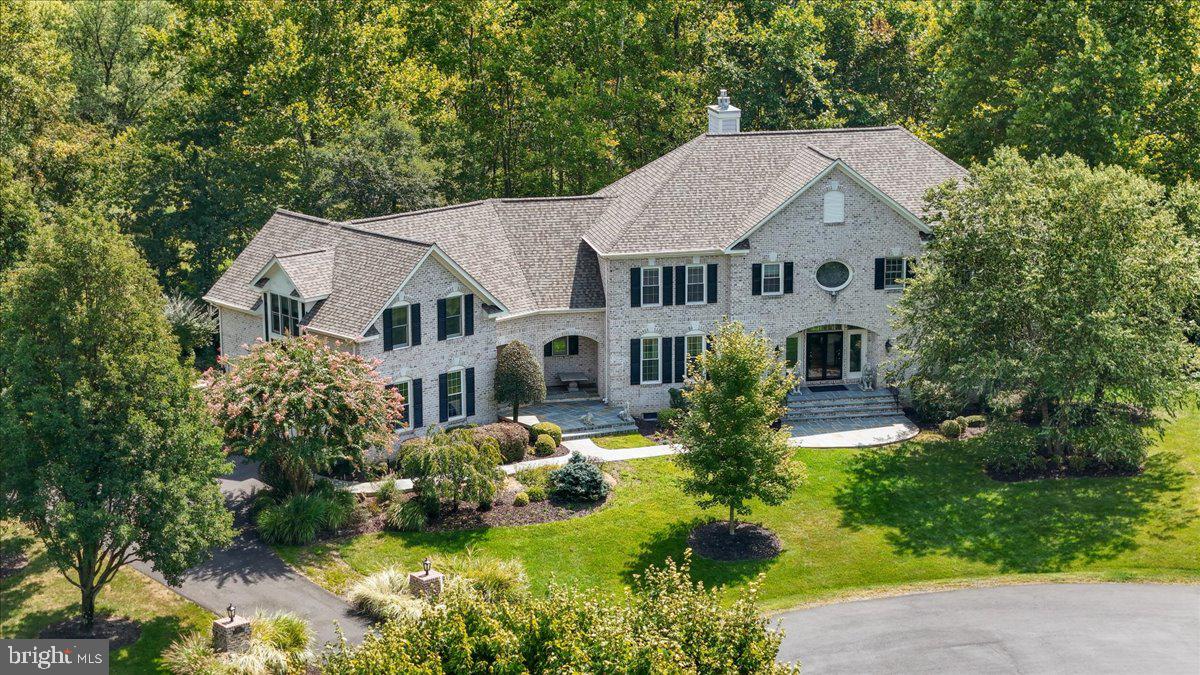 Beauty and convenience!  Centered on an expansive cul-de-sac, this luxurious 5 bedrooms, 5 1/2 bath home is nestled on 2.9-acres, with professional landscaping in a wooded surrounding. A beautiful natural setting yet close to the shopping/restaurants of Tysons, Reston and Vienna, the metro, Dulles toll road, Leesburg Pike, and the airport! The home is ideal for entertaining visiting family and friends or hosting large parties! A gracious front patio and walkway invites you into a welcoming foyer. The main level features an expansive two story family room with a wall of windows and a gas fireplace, a formal living room, dining room, and office. French doors lead to a large sunroom - a relaxing space with a wooded view - heated/cooled for year round enjoyment! The kitchen, with a large island, upgraded countertop and stainless-steel appliances is adjacent to sizable breakfast area. Off the sunroom is a large deck with eating area, built in gas grill, a resort-like infinity pool with swim jet, spa, and waterfall feature. On the second floor, the master suite includes a sitting area, gas fireplace, loads of closet space, and large luxury bath. There is also a beautiful, large “front to back” in-law suite with windows on three sides for plenty of light, a sitting/working area, and tons of built in shelves and closet space. The other two bedrooms each have their own ensuite bath. The huge lower level is an entertainer’s delight. The living room has a gas fireplace, wet bar and wine storage, and a pool table room. Glass doors lead out to an expansive patio featuring a cozy brick fireplace. This level also has an exercise room (which could easily become a 6th bedroom), a library/second office, and a lovely guest suite with windows overlooking the patio and an elegant bathroom. The entire lawn is surrounded by invisible dog fence. There is a large “deer proof”  fenced garden and a path leading to a walking/hiking/biking trail connecting to miles of bike trails.