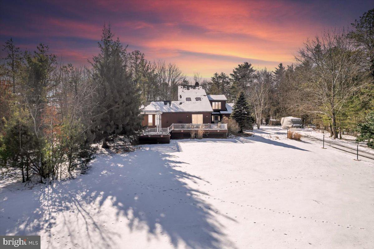 This amazing property on 3.5 acres has it all! Located down a dead end road, this home would make a great primary residence or short term rental. When arriving to the property you’ll immediately notice the long driveway lined with lampposts that lead to the home. Once inside, the hardwood floors, two story stone fireplace, and oversized windows in the main living area will capture your attention. Off of the living room the hardwood flooring continues into the dining area with tons of natural light and access to the kitchen and sunroom. The eat-in kitchen has beautiful cabinetry, granite counters, and updated appliances. Past the kitchen is a half bathroom, separate laundry area with exterior access, and a huge game room with access to the large front deck. There are also two nice sized bedrooms on this level with great closet space that share a full bathroom for one floor living! 
The second floor of this home has the primary bedroom one could only dream of! Cathedral ceilings, floor to ceiling brick fireplace, floor to ceiling windows overlooking the rear of the home, double walk in closets, and a huge primary bathroom with double vanities, jacuzzi tub, and shower. Outside of the primary bedroom is a loft area with built in shelving and a desk that overlooks the family room. 
Let’s not forget about the great outdoor area! The sunroom allows you to enjoy natures beautiful surroundings while staying nice and cozy in your home, but when  you venture outside you have your choice to entertain or relax in either your rear or front deck. 
The sellers are including all appliances and furniture in the sale, schedule your showing today!