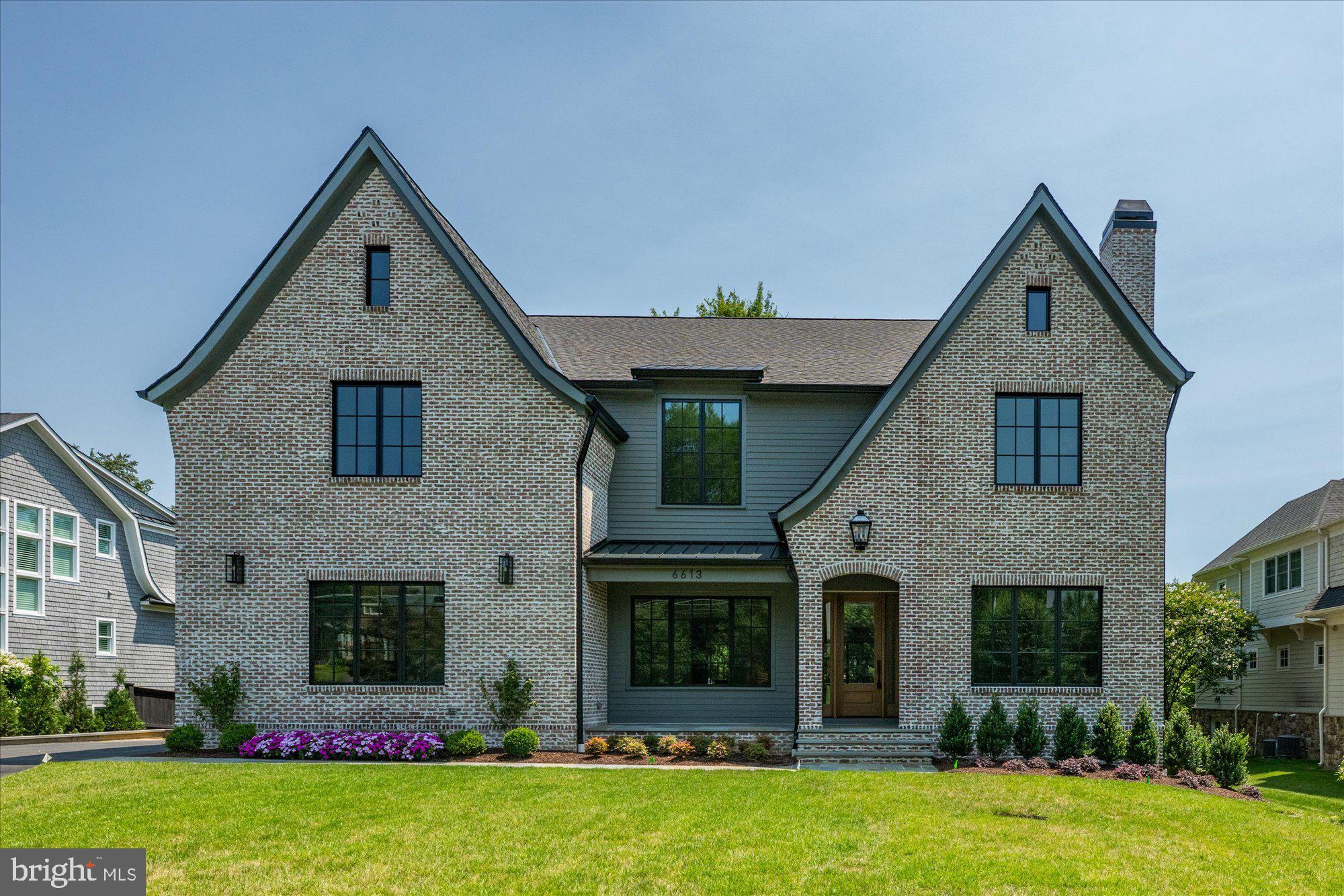 6613 Maugh Drive is Brush Arbor’s latest creation—crafted with intentionality and soul in collaboration with Wellhouse & Co & Jacobeen Architecture. Set on a rare, flat 0.46-acre lot and located in the most desirable part of downtown McLean’s Salona Village neighborhood due to its close proximity to shops and restaurants. 
A romantic English cottage-inspired exterior conceals over 9,400 square feet of thoughtfully designed interiors—six serene bedroom suites, seven full baths, two elegant powder rooms, and a combination of attached two-car and one-car garages. The structure is grounded by timeless architectural symmetry, where white oak flooring, moody paint palettes, and natural finishes define a refined, layered interior story.
Upon entry, a quiet sophistication unfolds. Custom millwork and both wide plank and herringbone white oak create a textural foundation, setting the tone for a home that balances richness with restraint. 

The kitchen and adjacent family room are anchored by thoughtful materiality—stone, wood, and custom cabinetry by Studio 37—while an oversized caterer’s kitchen elevates both form and function. Big, beautiful, and undeniably stylish, it offers a playful yet polished counterpoint to the elegant main kitchen.

Designer touches, oversized windows, and seamless sightlines create moments of calm and cohesion, each one curated by Wellhouse & Co to speak to luxury without excess. The result is a home that feels equally intimate and expansive, where no transition is abrupt and every corner tells a story.
Infrastructure includes prewiring for a future elevator, screened porch with fireplace, and abundant ceiling volume throughout. Outside, the private rear yard offers mature landscaping and space to imagine—whether for pool, play, or garden.
6613 Maugh Drive is the fullest expression of Brush Arbor’s craftsmanship—realized in partnership with Wellhouse & Co and completed with cabinetry by Studio 37. It is not a typical new build—it is a complete architectural experience, created for those who seek intentional luxury in every moment.
This is a home that must be experienced to be understood—and more importantly, felt.