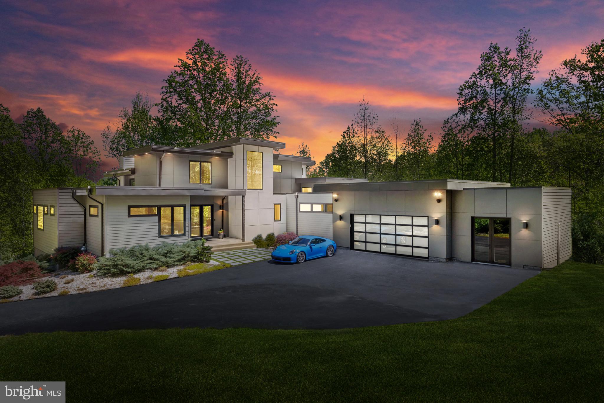 Introducing a captivating architectural gem nestled on a private 2-acre parcel. This refined and unique dwelling epitomizes contemporary design and upscale living. Upon arrival, you'll be captivated by its impressive facade featuring a durable 30-year TPO roof, stylish hardiplank siding, and black Pella Architectural Series casement windows. A welcoming 9-foot glass entrance seamlessly integrates with the lush surroundings and meticulously crafted outdoor space. Upon entering, this bespoke luxury home immediately captivates with its impeccable attention to detail and breathtaking aesthetics. The harmonious blend of sleek lines and classic color palettes leaves a lasting impression. The first floor is graced with expansive windows, luxurious plank bamboo flooring, and sturdy 8-foot core interior doors. The main level living area boasts a soaring 20-foot ceiling adorned with a mesmerizing stone feature wall and a contemporary linear gas fireplace complemented by a floating mantel. Culinary aficionados will delight in the gourmet chef's kitchen, featuring custom cabinetry, a spacious 9-foot island, pristine quartz countertops, and a convenient custom walk-in pantry. Expansive glass doors lead to a sprawling deck with refined steel cable railings, offering an idyllic outdoor retreat overlooking the inviting saltwater pool and charming fountains. Additional rooms on the main level feature lofty 10-foot ceilings, including the luxurious primary suite with a generous custom walk-in closet. The opulent primary bathroom offers a spa-like sanctuary, boasting a freestanding soaking tub and an oversized glass-enclosed shower. Dual quartz vanities and elegant tile flooring complete the lavish ambiance. A full-scale home office with custom bookshelves and storage on the main level caters to busy lifestyles, providing a serene workspace and added convenience. A second main level suite with its own bath ensures privacy and comfort for guests or family members. Adjacent to the garage, a mudroom with built-in cubbies and a spacious laundry room adds practicality. The second floor unveils two generously sized bedrooms, a spacious loft ideal for movie nights or relaxation, and a modern full bath appointed with modern fixtures. The walk-out lower level boasts 9-foot ceilings and abundant natural light, perfect for entertaining guests at the custom-built bar with quartz countertops and textured tiles. An expansive open recreation area offers a linear electric fireplace and custom built-ins, creating a setting for relaxation. Completing the lower level are a full-sized bedroom, full bath, bonus room and game room. A private studio, accessible from the garage or exterior entrance, has 12-foot ceilings, an elegant wainscot feature wall, and waterproof vinyl flooring, a versatile sanctuary suitable for a gym, studio, or additional office space. Walk outside of the basement level to a cozy patio with a gas firepit and plenty of seating, providing an outdoor haven for peace and socializing. The sparkling saltwater pool serves as the focal point of relaxation, providing months of rejuvenation and pleasure. You are just 4 miles south of 50 and 10 miles from downtown Annapolis. Convenient to Baltimore, BWI, Ft. Meade/NSA and Washington, DC. You literally have the best this region has to offer in a 30-mile radius. Welcome Home!