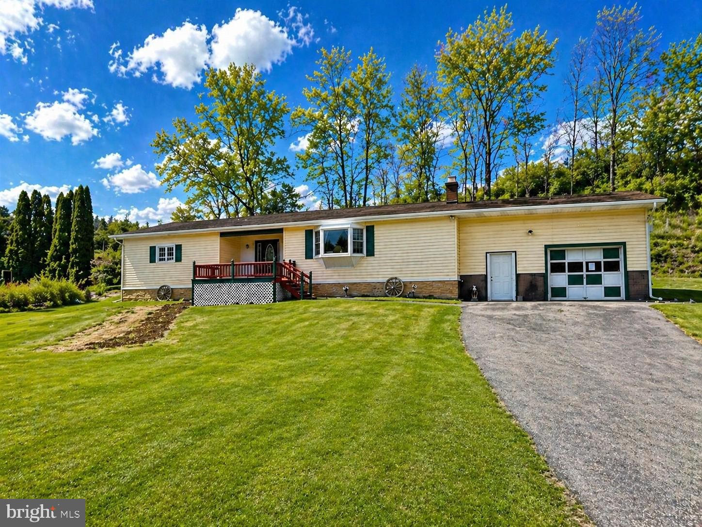 This single-family/manufactured home is situated in a quiet rural setting and offers a practical layout with room to grow. Fully remodeled in 2017, the interior features a large living room space with a cozy fireplace and bay window. An open kitchen layout connects the ground level back door and patio to the main living area, supporting comfortable daily living with optimal functionality. The house has 3 bedrooms and 1 full bathroom, with convenient potential to add an additional half bath in one of the bedrooms. The unfinished basement provides ample storage and future finishing potential with washer/dryer hookups. A large garage offers substantial space for vehicles, equipment, and a workshop. Outside, the front porch overlooks a large yard with plenty of room for gardening activities while maintaining simple upkeep. This property presents a solid opportunity for buyers seeking space while not being too close or too far from town. No equipment? No problem, the sale includes a pressure washer, snow blower and lawn mower.