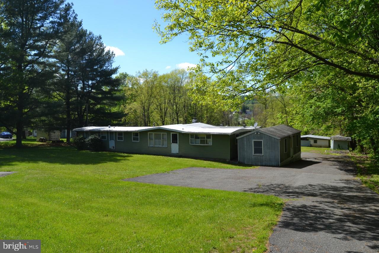 Three bedroom,  one bath mobile home with addition on a beautiful 3 acre open and wooded lot with a stream.Property is centrally located in berks county, Boyertown School district. Close to town with counrty living. Several outbuildings for storage or a workshop.  Small barn with space for animals.  Plenty of room for gardening and enjoy relaxing by the stream.  Come see all this property has to offer.