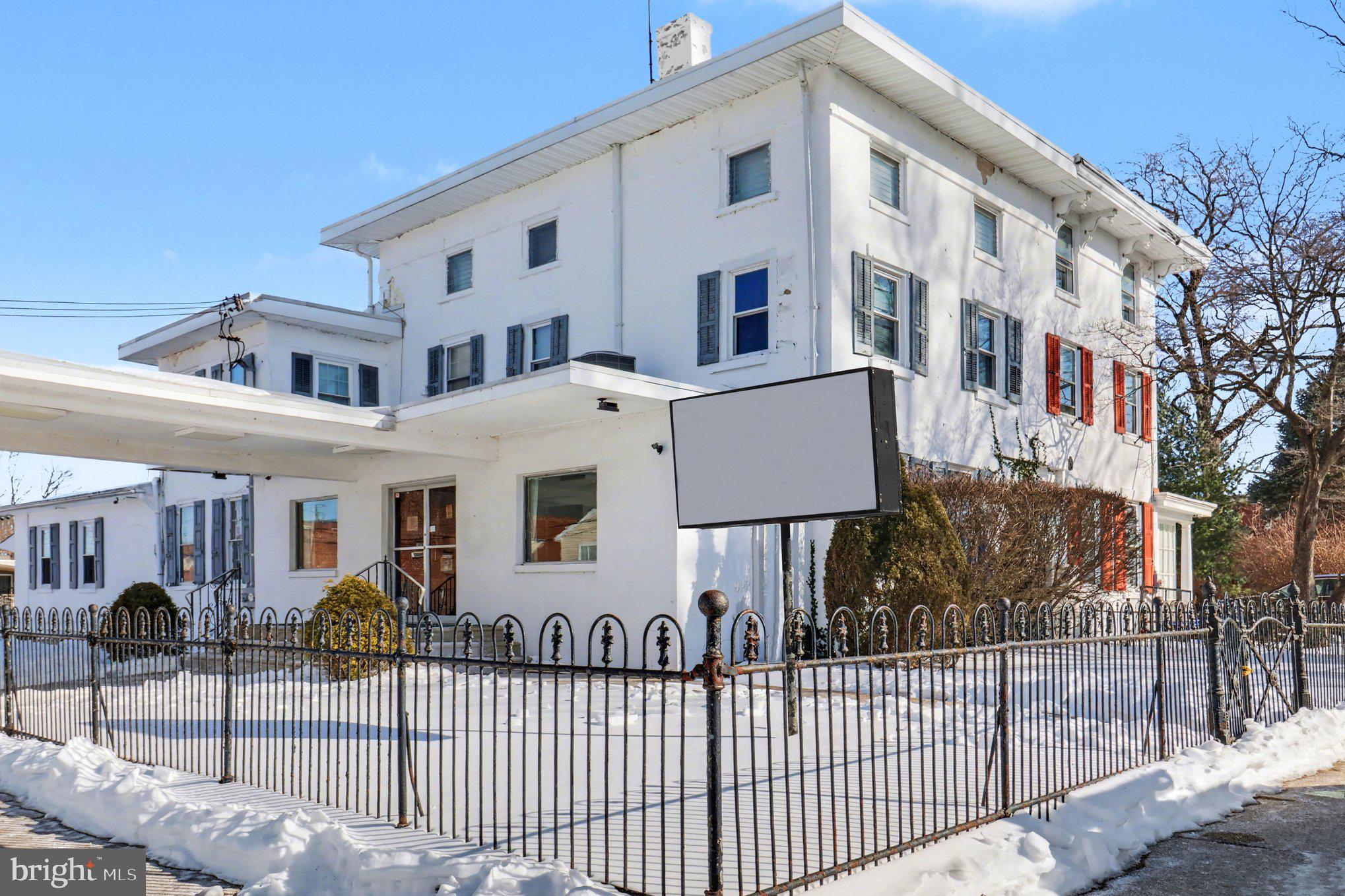 This is a rare opportunity to acquire a fully operational funeral home business offering a legacy of 82 years of compassionate service and a true turnkey operation.  There is also a spacious 3-bedroom apartment on the second and third floor ideal for the owner of the business to occupy or for additional income as a rental.  The sale includes 3 parcels, one is the main business and apartment, the second is the parking lot and garage/office, and the third is a vacant and buildable lot to the rear of the parking area. The main funeral home is a well-maintained, ADA-accessible facility featuring a spacious chapel with an adjoining sitting room for overflow and three restrooms for guests. The professional prep room is fully equipped with two 2-ton lifts—one built-in and one mobile—alongside a private office with a shower and storage. Comfort is maintained throughout the main level by efficient split-system heat pumps (cooling and heating). The property includes a secondary building that houses a three-bay garage and a professional office suite, which features a dedicated showroom for casket samples and private space for client consultations. High-end business infrastructure is a hallmark of this listing, highlighted by a state-of-the-art walk-in mortuary refrigeration system with a 9-remain capacity and a comprehensive 14-camera interior and exterior surveillance system that connects directly to a smartphone.  The residential component of the property offers a private retreat or an excellent rental opportunity with a separate entrance leading to the second and third floors. This 3-bedroom, 1-bath apartment is cooled by high-velocity central air and features a layout that includes a living room, kitchen with a laundry area, and two bedrooms on the second floor. The third floor is exceptionally versatile, currently configured as a third bedroom and additional living space with a large walk-in closet, though it is large enough to be utilized as two separate bedrooms. For additional utility, the property includes a full-size basement for storage and a full attic that houses the mechanical systems. Exterior features are equally impressive, consisting of a 25-car private parking lot, ample street parking, and an additional empty lot behind the garage included in the sale.  As a business, this family-run operation is deeply integrated into the community, currently handling 45–65 death calls per year and the sale can include 35 prearrangements already in place (with a referral paid to the current owner). The sale offers a seamless transition for a licensed director or an investor, as the current owner is willing to assist in transferring the "center of influence" and maintaining the established reputation for professionalism. With a strong client base, steady income, and the inclusion of all three parcels, this property represents a unique chance to continue a nearly century-old legacy of trusted service while benefiting from modern upgrades and significant real estate value.