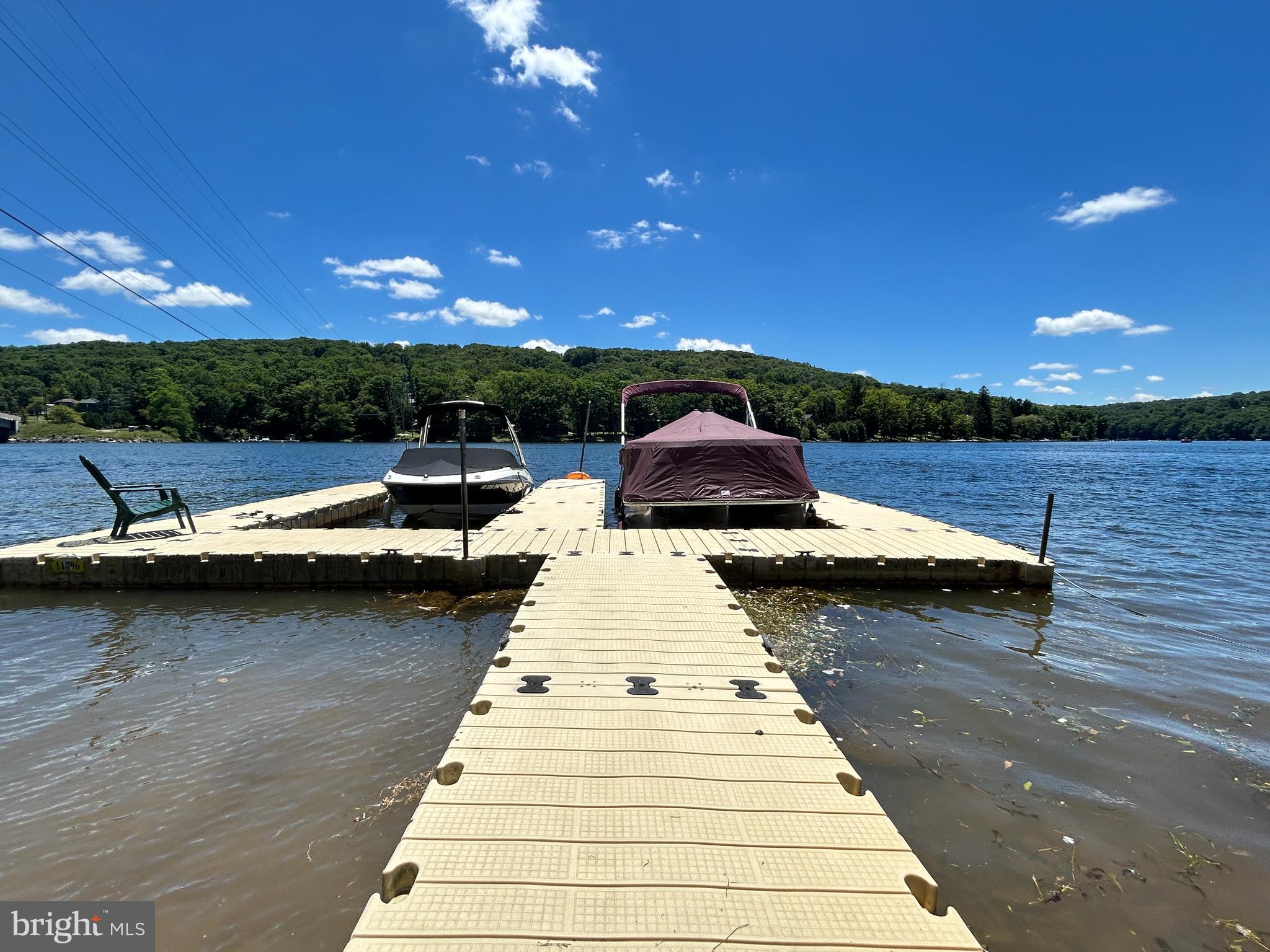 Turnkey Deep Creek Lake Mountain Cottage – Deeded Dock, Garage Game Room, & Prime Location!

Price: $639,900 | 4 BR | 3 BA | Fully Furnished | No HOA

Welcome to your ultimate mountain and lake escape!
Nestled in the serene mountains surrounding Deep Creek Lake, Maryland, this charming 4-bedroom, 3-full-bathroom cottage offers the perfect blend of rustic warmth, modern entertaining, and unmatched convenience.

Selling fully furnished and completely turnkey, this home is ready for you to bring your bags and move right in. It also features a current TVRU license, offering fantastic rental potential if desired. Best of all, there are no HOA restrictions or fees, giving you complete control over your property.

Close to Everything You Love!
Positioned perfectly in the heart of the area, you are just minutes away from everything Deep Creek Lake has to offer:
Dining & Nightlife: A short drive to the lake’s best waterfront restaurants, local eateries, and lively bars.
Four-Season Activities: Minutes from Wisp Resort for skiing, snowboarding, and golfing, as well as local state parks for hiking, waterfalls, and swimming.
Convenience: Close to local shops, marinas, groceries, and family entertainment centers.

Lake Life Made Easy (Golf Cart Friendly!)
Skip the heavy lifting. This property includes a highly coveted deeded dock slip providing direct, hassle-free lake access. Your deeded dock is just a scenic, 4-minute golf cart ride away, making it effortless to spend days boating, fishing, and swimming.

The Ultimate Family "Man Cave" & Garage!
The crown jewel of entertainment is the brand-new, detached garage completely transformed into a massive family game room and hangout hub.
It features:
•Custom built-in bar for hosting game days.
•Dedicated spaces for entertainment, large-screen TVs, and arcade games.
•Ample secure storage with a designated parking space for your golf cart.

Extensive Outdoor Living Spaces-
Embrace the Deep Creek lifestyle with outdoor areas designed for ultimate relaxation and hosting:
•Updated Wrap-Around Deck: Perfect for morning coffee, alfresco dining, or catching mountain breezes.
•Classic Porch Swing: A cozy spot to unwind.
•Private Hot Tub & Fire Pit Area: Unwind under the stars after a day on the lake or the ski slopes.