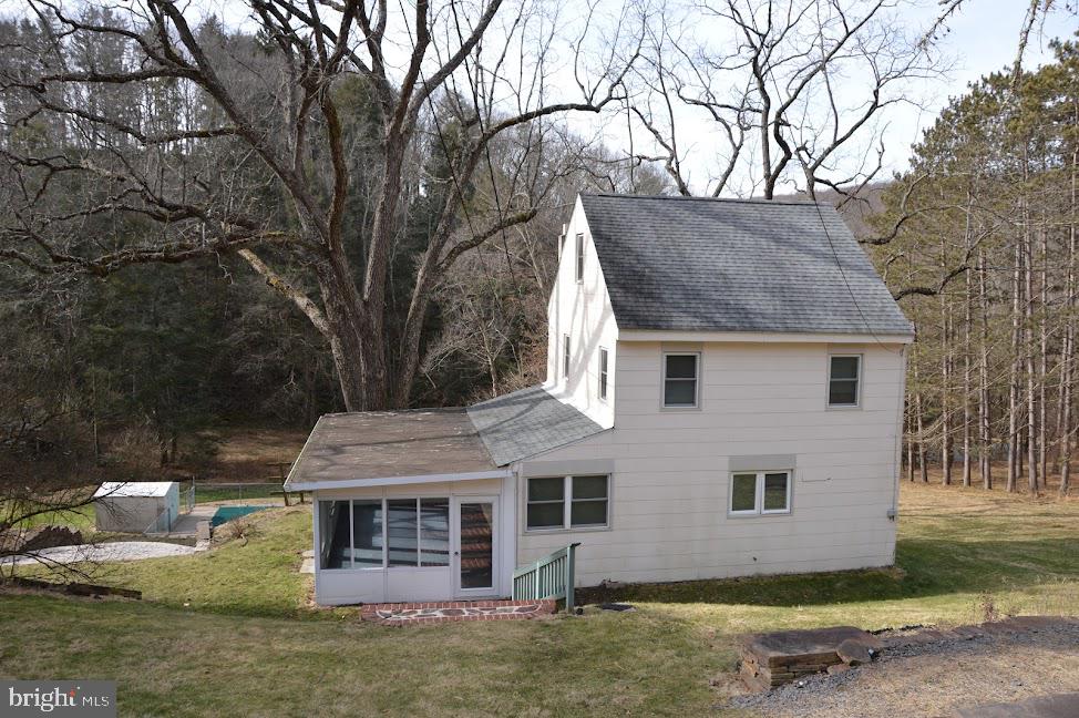 Looking for a charming detached home or a quiet "get-a-way?"   This cottage may be the perfect place!
Relax and unwind poolside while listening to the soothing sounds of the nearby creek.   This home offers a bright sunroom and open floor plan.   Updated kitchen 2018 and new windows 2021.   Second floor hosts 3 bedrooms that are only heated by "rising heat."  Home features oil heat, wood burning stove in living room, and an electric heat source on the third floor.   Third floor features a large finished attic or fourth bedroom.  Inground pool.   Shed/barn for storage.  One acre lot.  Call for more information.