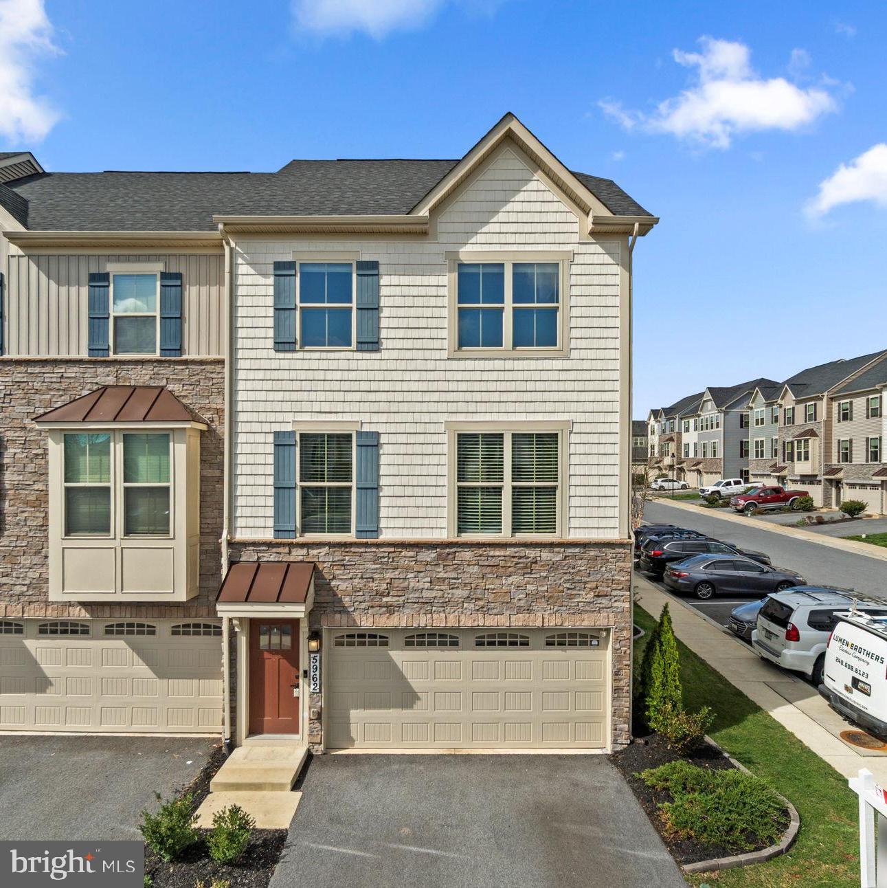 Updated, stone-accented end-of-row townhouse built in 2020 by Ryan Homes and meticulously maintained by the original owner, offering 2,412 square feet, 3 bedrooms, 3 full baths, 1 half bath, and a 2-car garage. Located in Lake Linganore Eaglehead, this home is the largest unit and sits on the largest lot in the community. The open-concept main level features gleaming luxury vinyl tile floors throughout the spacious, sunlit living and dining areas, as well as the gourmet eat-in kitchen. Highlights include granite countertops, stainless steel appliances with a gas range, and a large island breakfast bar with two lighted hanging pot racks above. A convenient powder room completes this level. Upstairs, you’ll find three carpeted bedrooms, two full bathrooms, and a laundry room. The primary suite offers a tray ceiling, a walk-in closet, and a private bath with dual sinks, a soaking tub, and a separate shower. The fully finished lower level includes a large recreation room with a third full bathroom. Outdoor features include a deck with steps leading to a flat, landscaped backyard, green space, and a stepping stone path to a lower patio. Enjoy Lake Linganore community amenities, including a community pool.