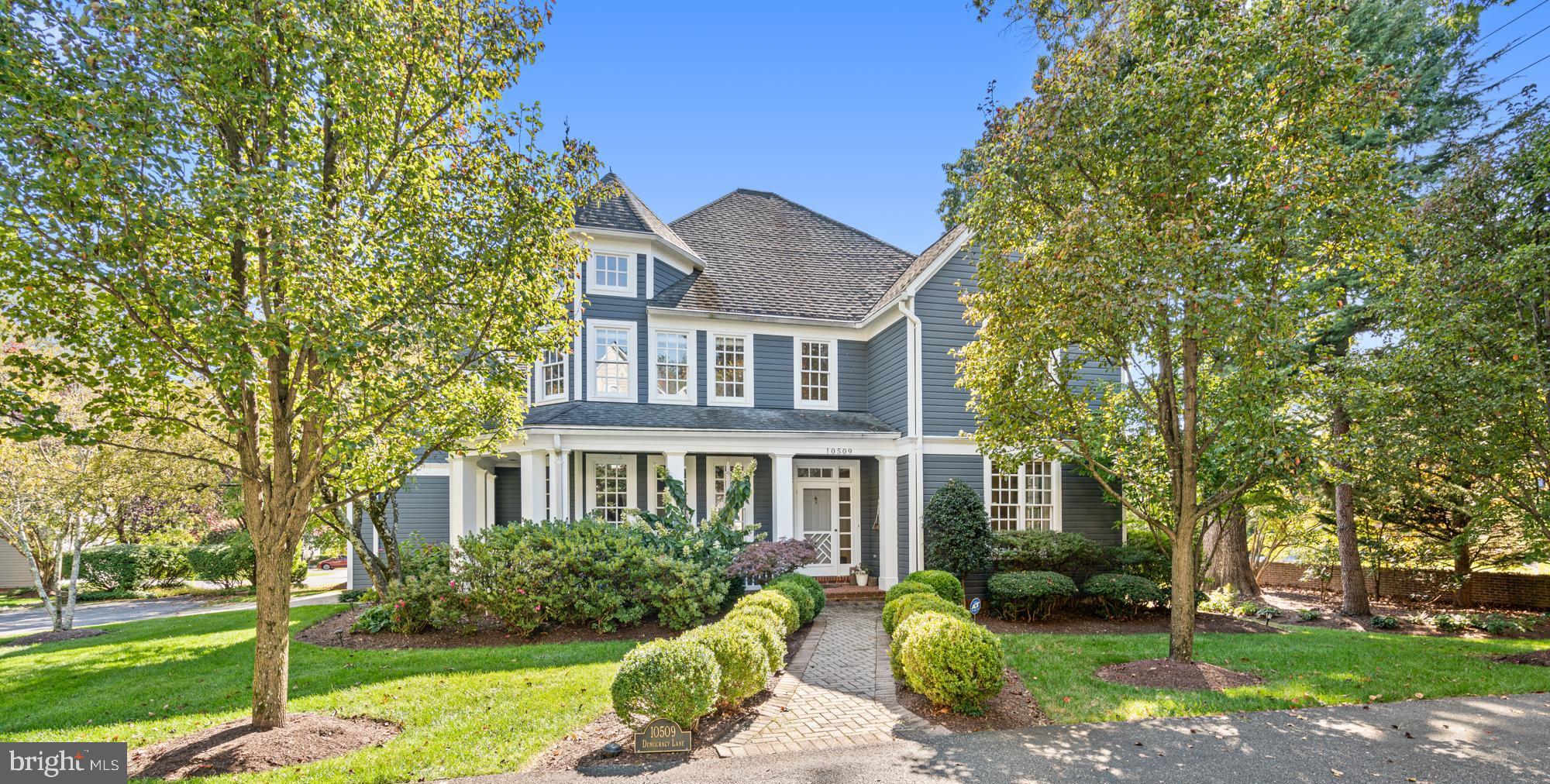 Ideally located on a quiet cul-de-sac off Democracy LANE, this custom-built Nantucket-style home is truly one-of-a-kind.  Located in the Courts of Democracy, a development of just 12 delightful residences, not in an HOA.  The dramatic, welcoming two-story foyer sets the tone for the elegance found throughout this turn-key home. The main level boasts a light-filled living room, formal dining room, chef’s eat-in kitchen, and a spacious family room with dramatic ceiling height, native stone gas fireplace and double doors to the sun-filled deck.  The gourmet kitchen features stainless steel appliances including a SubZero refrigerator, island with countertop seating, custom cabinetry and plantation shutters. Charm and sophistication abound; flooded with natural light, gleaming hardwood floors, recessed lighting, and incredible ceiling height throughout the home.
 
The natural light-filled upper level features a luxurious primary retreat with a sitting room, two walk-in closets, vaulted ceilings, and a recently renovated spacious spa-like ensuite bathroom. Three more nicely sized additional bedrooms and two full bathrooms, one ensuite, round out the upper level.
 
The lower level offers even more living space with an additional bedroom, full bathroom, office space, recreation room with a wood burning fireplace, generous laundry room as well as a storage room. The attached two-car garage has additional storage space along with an electric vehicle charger. Additional guest parking for four cars. Enjoy this tranquil setting on the wraparound porch or the rear deck, open to the professionally landscaped yard, private and low maintenance with an inground sprinkler system. 
 
Conveniently located near Cabin John Mall, Cabin John Park & Ice-Skating Rink, Montgomery Mall, and an abundance of swim, tennis, and recreational parks, giving residents easy access to a variety of amenities. Bells Mill ES, Cabin John MS, and blue-ribbon Churchill High School serve the neighborhood. This property offers a perfect combination of elegance, functionality, and convenience, making it a truly turn-key home. Welcome home! 
 
* Please note: this property is on Democracy Lane, not Boulevard. *