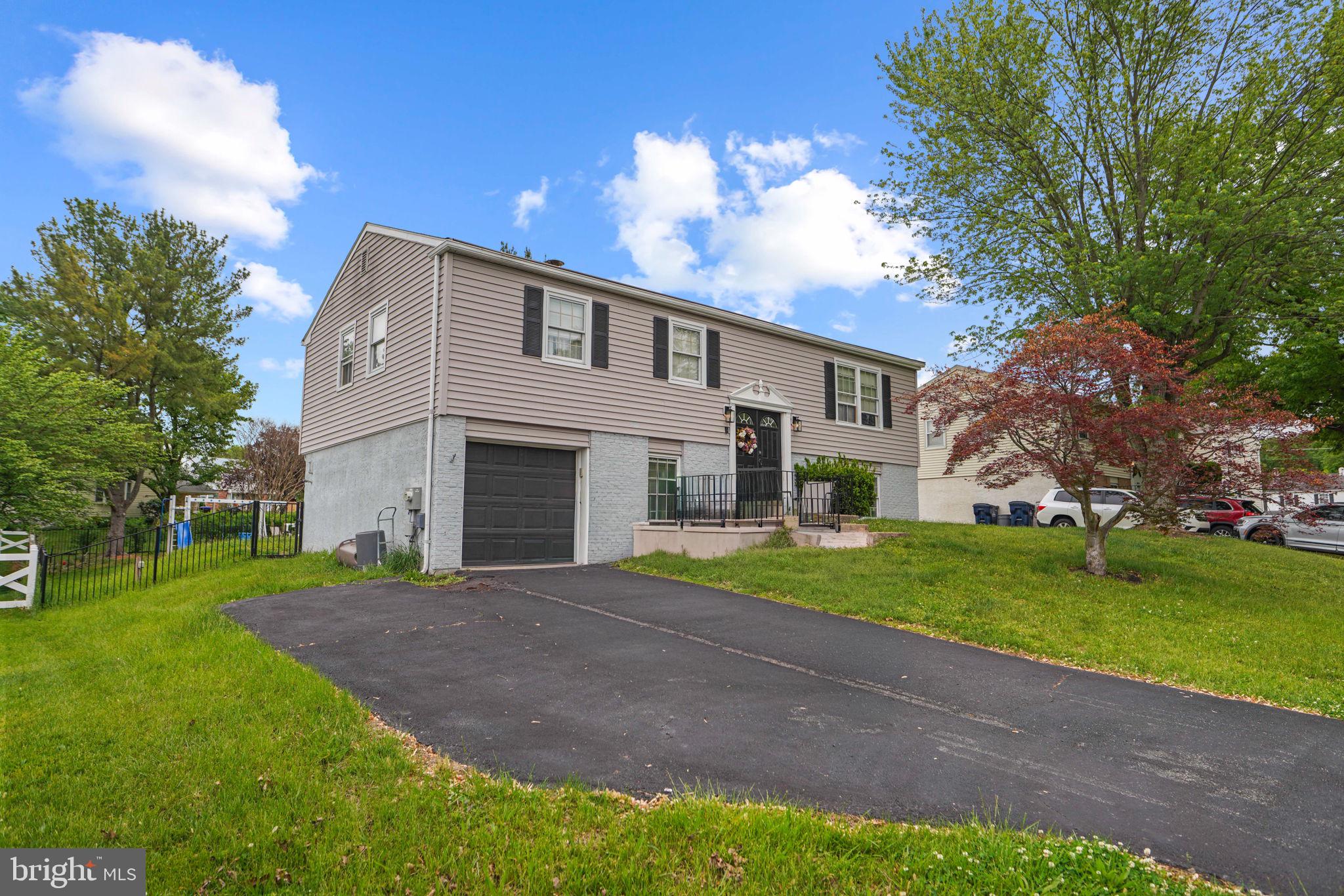cordially invites you to enter 908 Mennonite Road located within the highly sought after Spring-Ford School District! The pool and modern elegance greet you as you enter the doorways and begin to explore the nearly 1,700 square feet of living arrangements. Enter up the stairs into an expansive living room with original moldings and chestnut accented hardwood floor highlighted by all the natural light from the surrounding  windows. This bi-level home offers a full size upper level living space adjacent to the formal dining area and designer kitchen. The kitchen has been hand selected with top of the line selections including black quartz countertops, white shaker cabinetry,  a complimenting tiled backsplash as well as a stainless steel appliance package. Located along this upper level are two large  sized bedrooms each spacious and roomy with enough closet space for belongings. These bedrooms share a recently designed full hall bathroom with elegant tile work done throughout! Completing this upper level is the primary suite, featuring a generously sized bedroom with a giant closet and full spa-like bathroom with a glass enclosed sliding shower stall. Venture downstairs to an extremely spacious family room with additional hardwood flooring with a brick fireplace for added charm. A fourth bedroom is located on this lower level off to the side. The luxury and entertaining will continue to be felt as you make your way out doors to the rear yard. Out back is a concrete patio with green space leading you to the very large in-ground pool, waiting for you to bring your blueprint and designer finishes.  This home is close to the Collegeville Town Center, a modern center of top restaurants, shops, grocery stores, and the Movie Tavern, Wegmans and others! Upgraded and  ready for someone to enjoy , consider adding seeing 908 Mennonite Road to your list of homes today!