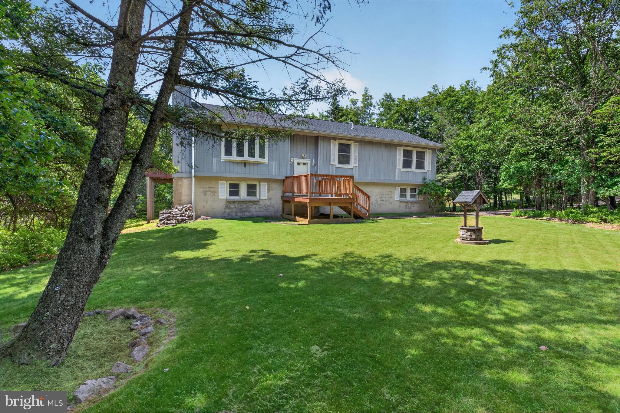 Great opportunity to own a 3-bedroom, 3-bath bi-level home in the amenity-filled Indian Mountain Lakes community in the heart of the Poconos. Situated on 1.01 acres, this home offers a spacious layout with an open living and dining area, cathedral ceilings, skylights, and multiple levels of living space—ideal for a primary residence, long-term rental, or second home. The finished lower level provides additional flexibility with a large family room, bonus space, laundry area, and access to the attached 2-car garage. Enjoy the peaceful wooded setting from the oversized deck while taking advantage of community amenities including lakes, pools, clubhouse, playgrounds, and 24-hour gated security. Conveniently located near major routes, shopping, skiing, hiking, and other Pocono attractions, this property offers strong appeal for both owner-occupants and long-term rental investors.