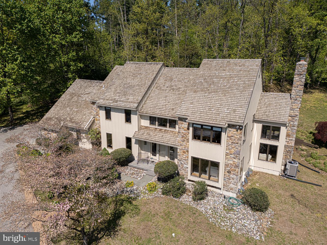 Ideally situated just minutes to downtown Media this stunning contemporary  two story home is perfectly poised on a gorgeous one acre lot. Elegant two story foyer, Living room with hardwood floors and French doors leading into the family room boasting a beautiful wood burning stone fireplace. Another set of French doors lead to the private deck which overlooks the rear yard with a park like setting. Stately kitchen with gleaming Corian countertops and hardwood floors. Butler's pantry with wine refrigerator and plenty of counter space for entertaining. Formal dining room, convenient first floor laundry room with window, mud room and powder room. Entrance to the three car garage. The second floor features a spacious master bedroom retreat with two large closets, his and her vanities and private ensuite bath with Jacuzzi tub, ceramic tile floor and beautifully tiled stall shower. 3 additional nicely sized bedrooms and well appointed hall bathroom. Pull down stairs to the attic. Complete with a full finished basement ideal for family movie night, home fitness center or storage.  The composite siding is new and the cedar shake roof is in excellent condition. The perfect location within the acclaimed Rose Tree Media School District. Everyone loves downtown Media with it's boutique shops, fun restaurants and lively night life including the Media Theatre and other attractions. Also enjoy the Tyler Arboretum and Ridley Creek State Park only a few minutes away.