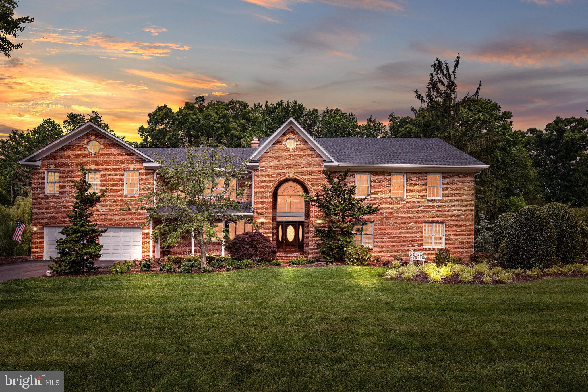 Nestled in the highly sought after neighborhood of Mantua, this one of a kind home is situated on a tranquil street on a rarely available 1.49 acre lot.  Beautiful landscaping and mature trees create the perfect picturesque backdrop.  Offering 8 bedrooms and 7.5 baths, this home boasts expansive spaces for entertaining and family living.  Oversized windows allow for an abundance of natural light to flow throughout the home.  The main level features an in-law suite, large gourmet kitchen, with a breakfast bar island, double oven, stainless steel appliances and custom cabinetry.  The kitchen also allows access to the terrace where you'll enjoy views overlooking the patio and extensive backyard which backs towards the trees.  Adjoining the kitchen is the sun drenched family room which encompasses large windows and a wood burning fireplace for those cozy evenings.  Completing the main level is the living room, a charming breakfast room with fireplace, adjacent office/den with handsome built-ins and cabinetry, separate formal dining room and a screened in porch highlighting multiple skylights making this the perfect setting to lounge and admire the stars above or just gather amongst family and friends.  The upper level features the large primary suite showcasing tray ceilings, sitting area, wet bar, gas fireplace and 2 generous walk-in closets.  En-suite has double vanities, jetted soaking tub, separate shower and enclosed water closet.  Bedrooms 2 & 3 include en-suite baths.  Jack & Jill bath is shared between bedrooms 4 & 5.  The finished walk-out lower level has a secondary family room, game area, 2 additional bedrooms and adjacent full bath.  At the end of the day, take a soak and relax in your heated indoor spa located in the light filled sunroom.  Laundry and utility room are also on the lower level.  Plenty of storage on all levels of this spacious home.  Garage parking for 4 and added carport can house 2 additional vehicles.  Roof replaced in 2022.  Upper level was added in 2003 to allow for more bedrooms.  Lower level bar area is in the process of being completed.  Community offers parks, trails, swim & tennis club.  Membership available for purchase.  Woodson High School pyramid.  Favorite restaurants, shops and entertainment are just minutes away at The Mosaic District, Tyson's Corner and Fairfax City.  Close to the Vienna Metro, I 66 & I 495.  A bit of history, the antique brick used to build this elegant home was salvaged from a now defunct DC Hospital.  Come and make this home yours today!