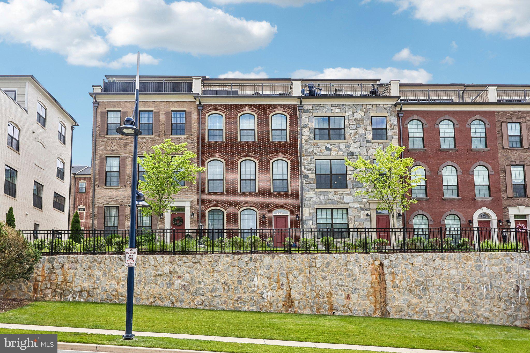 Welcome to 606 Skiff Way, a meticulously maintained all-brick townhome in the sought-after Potomac Overlook community at National Harbor. Built in 2023, this elegant four-level residence offers thoughtfully designed living space, modern finishes, and exceptional functionality throughout. A premium location within the community allows for exceptional natural light throughout all four levels, creating a bright and inviting atmosphere that enhances every living space.

The entry level features a versatile flex room that can easily serve as a recreation room, media room, fitness area, guest retreat, or additional home office. A convenient half bath and direct access to the oversized two-car garage complete this level.

The main living level is designed for both everyday living and entertaining, featuring an open-concept floor plan centered around a gourmet kitchen with a large island, abundant cabinetry, and generous prep space. The adjoining dining area and spacious family room with fireplace create a seamless flow ideal for gatherings both large and small. Large windows fill the space with natural light, while a dedicated work-from-home area for added flexibility. 

The third level offers a luxurious primary suite featuring a spacious walk-in closet and spa-inspired bathroom highlighted by an oversized walk-in shower. A generously sized secondary bedroom with its own en-suite bath, along with a dedicated laundry area, provides comfort, convenience, and privacy for family members or guests.

The uppermost level delivers exceptional versatility with an additional bedroom, full bath, and expansive loft-style living area with floor to ceiling sliding doors. From here, step outside to the private rooftop terrace, the perfect setting for outdoor dining, entertaining, morning coffee, or relaxing evenings under the stars.

Additional highlights include hardwood flooring, high ceilings, recessed lighting, modern finishes, abundant storage, and an attached rear-entry two-car garage.

Commuters will appreciate the home's convenient access to I-495, I-95, National Harbor Boulevard, Metrobus service, and the Oxon Hill Park & Ride. Ideally situated just minutes from National Harbor's waterfront restaurants, shopping, entertainment venues, MGM National Harbor, Tanger Outlets, Old Town Alexandria, and Downtown Washington, D.C., this location offers the perfect blend of accessibility and lifestyle.

Experience elevated living in one of Prince George's County's most desirable communities, where modern design, exceptional natural light, and an unbeatable location come together to create a truly special place to call home.