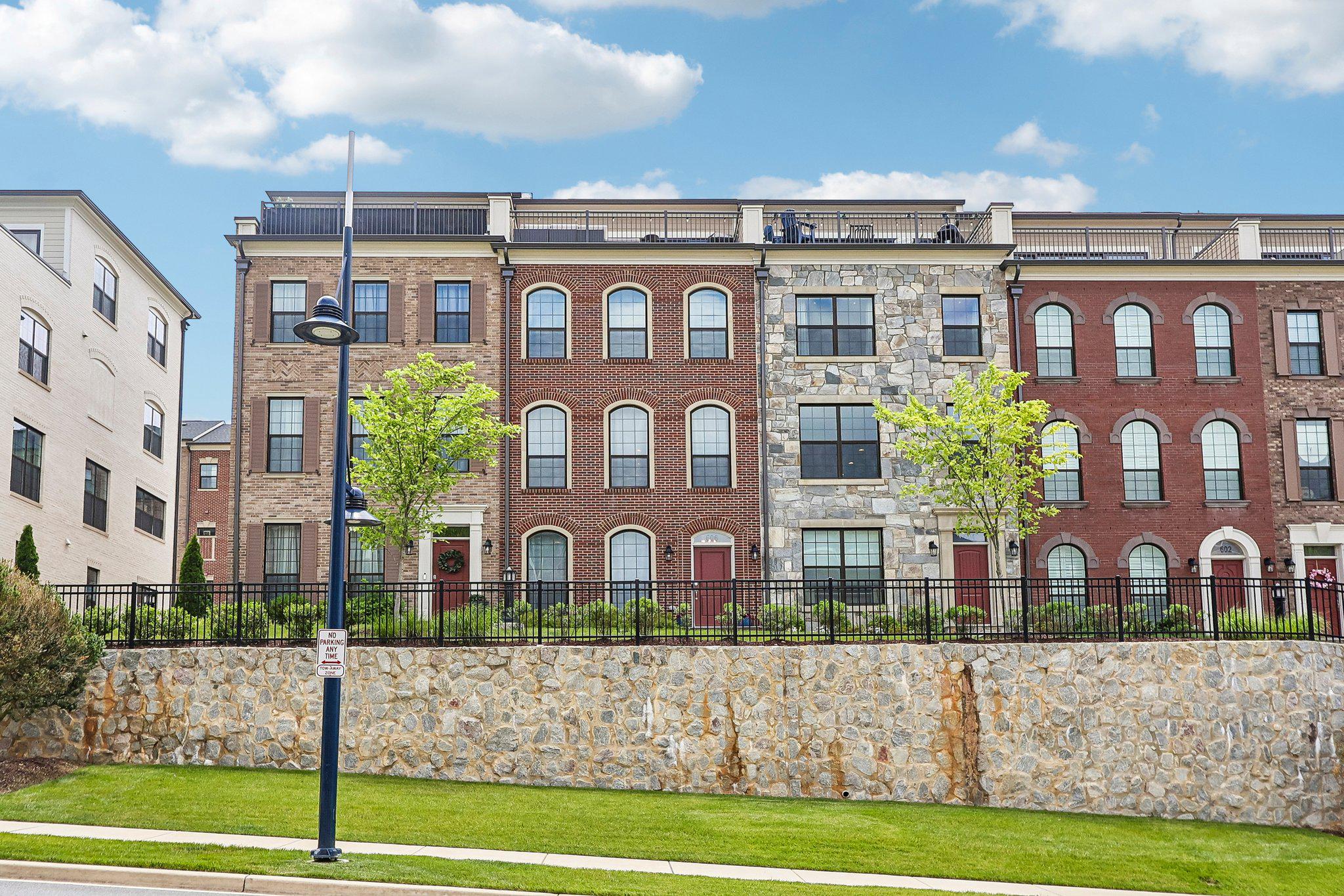 Welcome to 606 Skiff Way, a meticulously maintained all-brick townhome in the sought-after Potomac Overlook community at National Harbor. Built in 2023, this elegant four-level residence offers thoughtfully designed living space, modern finishes, and exceptional functionality throughout. A premium location within the community allows for exceptional natural light throughout all four levels, creating a bright and inviting atmosphere that enhances every living space.

The entry level features a versatile flex room that can easily serve as a recreation room, media room, fitness area, guest retreat, or additional home office. A convenient half bath and direct access to the oversized two-car garage complete this level.

The main living level is designed for both everyday living and entertaining, featuring an open-concept floor plan centered around a gourmet kitchen with a large island, abundant cabinetry, and generous prep space. The adjoining dining area and spacious family room with fireplace create a seamless flow ideal for gatherings both large and small. Large windows fill the space with natural light, while a dedicated work-from-home area for added flexibility. 

The third level offers a luxurious primary suite featuring a spacious walk-in closet and spa-inspired bathroom highlighted by an oversized walk-in shower. A generously sized secondary bedroom with its own en-suite bath, along with a dedicated laundry area, provides comfort, convenience, and privacy for family members or guests.

The uppermost level delivers exceptional versatility with an additional bedroom, full bath, and expansive loft-style living area with floor to ceiling sliding doors. From here, step outside to the private rooftop terrace, the perfect setting for outdoor dining, entertaining, morning coffee, or relaxing evenings under the stars.

Additional highlights include hardwood flooring, high ceilings, recessed lighting, modern finishes, abundant storage, and an attached rear-entry two-car garage.

Commuters will appreciate the home's convenient access to I-495, I-95, National Harbor Boulevard, Metrobus service, and the Oxon Hill Park & Ride. Ideally situated just minutes from National Harbor's waterfront restaurants, shopping, entertainment venues, MGM National Harbor, Tanger Outlets, Old Town Alexandria, and Downtown Washington, D.C., this location offers the perfect blend of accessibility and lifestyle.

Experience elevated living in one of Prince George's County's most desirable communities, where modern design, exceptional natural light, and an unbeatable location come together to create a truly special place to call home.