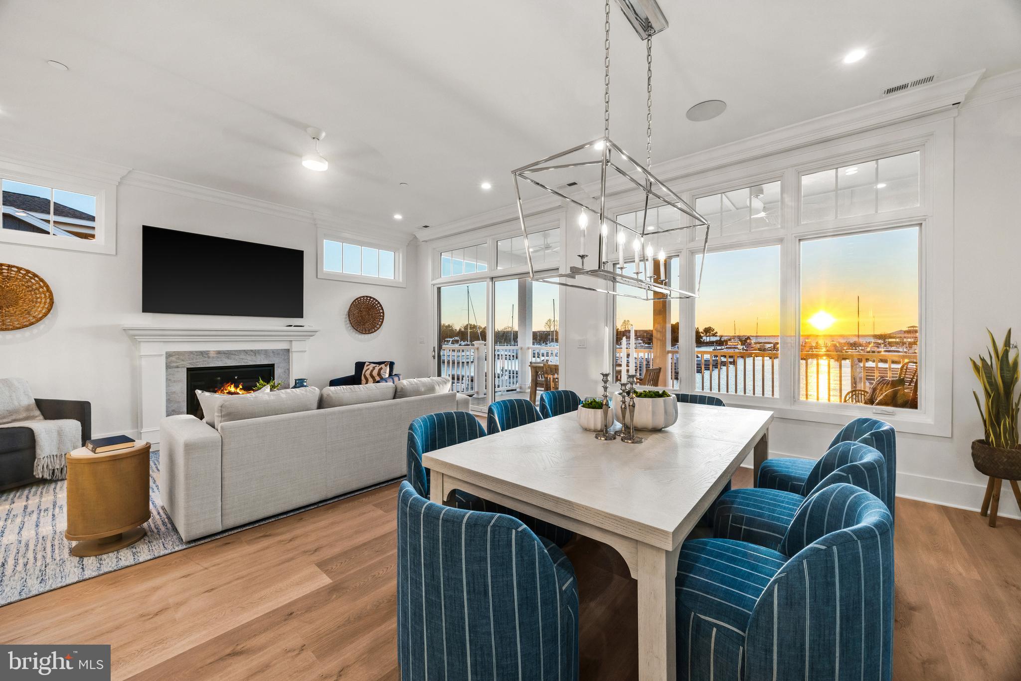 Welcome to Sunset Wharf, a refined waterfront enclave set within the picturesque Bay Bridge Marina, where coastal living is defined by sweeping views and effortless sophistication. This fully completed residence is one of just a select offering within the initial collection of three buildings, each thoughtfully designed with only two residences each, creating an intimate and private setting along the water’s edge.

Inside, the home unfolds across three levels with a thoughtfully designed four bedroom, four bath layout that offers both flexibility and comfort. A private bedroom and full bath on the entry level provide the perfect space for guests or a quiet home office. The main living level is designed for seamless everyday living and entertaining, highlighted by a warm and inviting living room with a gas fireplace that adds both comfort and ambiance. The upper level features two additional bedroom suites, including a serene primary retreat complete with its own gas fireplace. An elegant touch that enhances the sense of relaxation and retreat.

Expansive windows frame captivating views over the marina and out to the Chesapeake Bay, filling the home with natural light and creating an ever-changing backdrop of boating activity and open water. As the day winds down, the setting truly comes to life with breathtaking sunsets that paint the sky and reflect across the water. An experience to be enjoyed from both the interior living spaces and outdoor areas.

High-end finishes and a modern, open-concept design elevate the interiors, while the beautifully appointed gourmet kitchen and well designed baths enhance both form and function. Every detail has been curated to deliver a low-maintenance, lock-and-go lifestyle without compromising on luxury.

Ideally positioned within walking distance to waterfront dining, including Libbey’s Coastal Kitchen & Cocktails and Knoxie’s Table, residents also enjoy immediate access to marina amenities, scenic walking paths, and the relaxed rhythm of life on the Bay. Sunset Wharf offers a rare opportunity to own a newly completed residence in a thoughtfully designed waterfront community where every day feels like a getaway. Welcome Home!