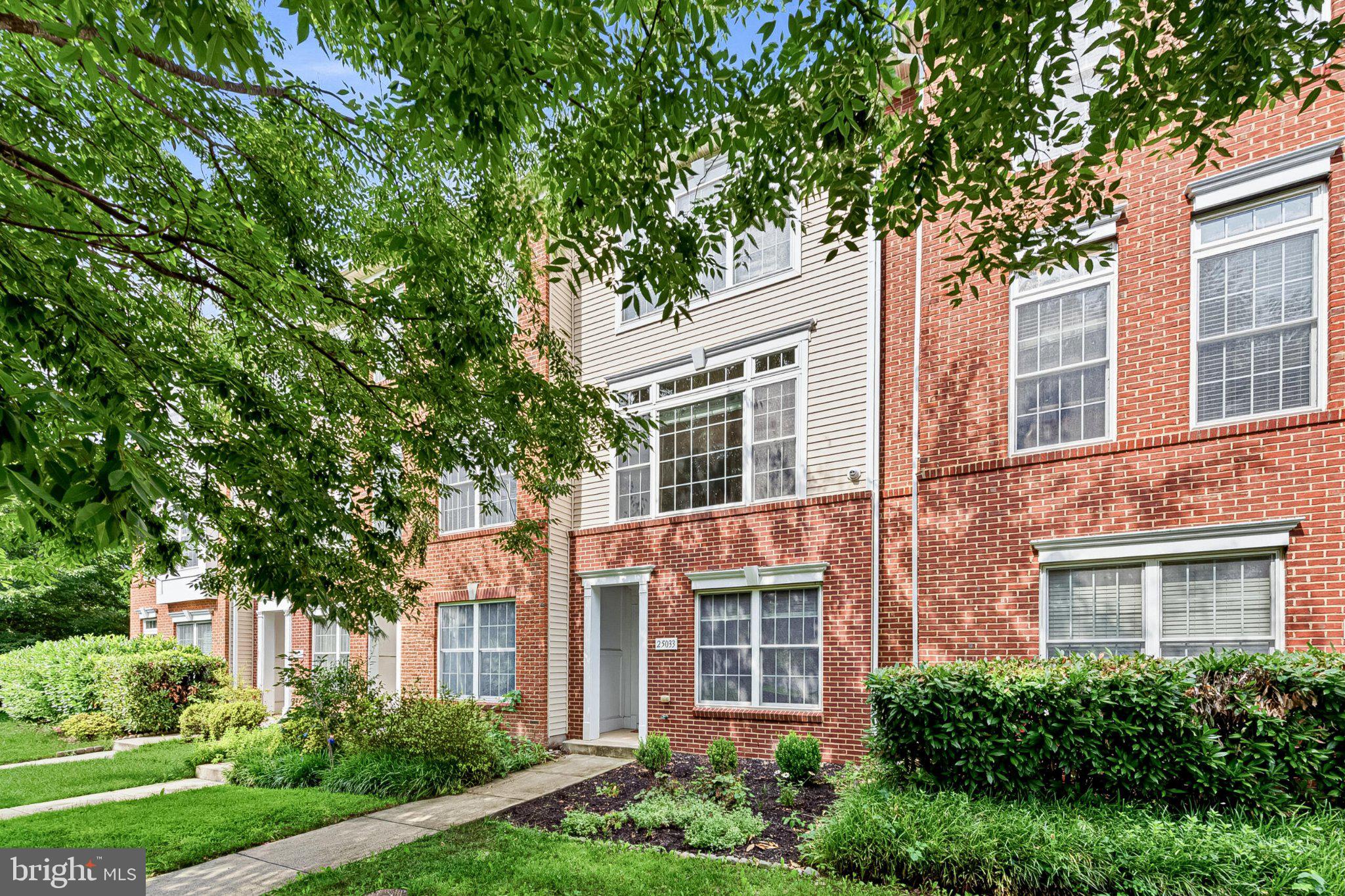 Overlooking mature trees and filled with natural light, this beautifully maintained South Riding townhome offers the perfect blend of warmth, functionality, and low-maintenance living. Thoughtfully designed across three finished levels, it features inviting living spaces, tasteful updates, and the everyday conveniences that make coming home the best part of the day.

The welcoming foyer opens to the lower level, where a private bedroom suite with hardwood flooring and an adjacent full bath creates the perfect space for overnight guests, a private home office, or a quiet retreat. A coat closet, utility closet, and rear-entry single-car garage with built-in cabinetry provide exceptional everyday storage, while the private driveway offers additional parking.

Upstairs, hardwood floors and abundant natural light create an inviting atmosphere throughout the open-concept main level. The spacious living and dining areas flow effortlessly together, creating a comfortable space for gathering with family and friends. At the heart of the home, the kitchen features granite countertops, a center island with seating, stainless steel appliances, gas cooking, recessed lighting, a pantry, and additional custom cabinetry and shelving thoughtfully added by the current owner to maximize both storage and functionality. Just beyond the kitchen, the deck provides the perfect place to enjoy morning coffee, dine outdoors, or simply unwind at the end of the day. A powder room and dedicated laundry room with ceramic tile flooring, cabinetry, and a washer and dryer complete this level.

The upper level offers a spacious primary suite with vaulted ceilings, a ceiling fan, walk-in closet, and private en suite bath featuring dual vanities and a tub/shower combination. A generously sized second bedroom also includes a walk-in closet and is served by a full hall bath, while a convenient linen closet provides additional storage.

Recent updates provide a fresh, move-in-ready feel, including new interior paint throughout (2026), along with recently replaced lighting fixtures, carpeting and updated kitchen appliances, including the refrigerator, gas range, and dishwasher.

Beyond the home, enjoy all that South Riding has to offer. Residents have access to an exceptional collection of amenities including multiple pools, tennis and pickleball courts, sports fields and courts, tot lots, walking trails, a dog park, scenic ponds, and countless opportunities to enjoy the outdoors and connect with neighbors.

Perfectly positioned near the Dulles South Recreation & Community Center, schools, grocery stores, restaurants, Home Depot, and everyday conveniences, this location also offers easy access to Route 50, Route 28, the Dulles Greenway, and Dulles International Airport.

Whether you're entertaining friends, enjoying a quiet evening on the deck, or simply settling in after a busy day, this South Riding townhome offers the comfort, connection, and effortless lifestyle that makes every day feel a little more like home.