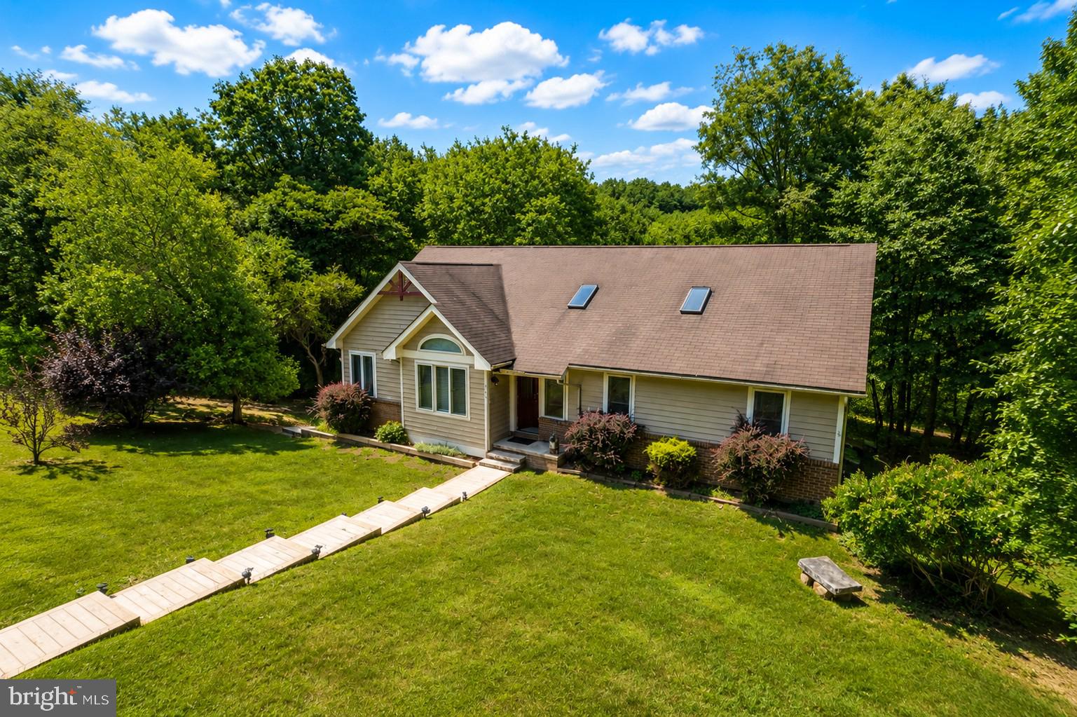 Welcome to this beautifully maintained 5-bedroom, 3-bath mountain retreat in The Pinnacle, one of Deep Creek Lake's most desirable lake access communities. Offering two fully finished levels, an attached garage, and a proven vacation rental history, this home is the perfect blend of comfort, recreation, and investment potential.

The spacious main level features an open-concept living room, dining area, and kitchen designed for gathering family and friends. Vaulted ceilings, abundant windows, updated luxury vinyl plank flooring, a cozy gas fireplace, mini-split air conditioning, and upgraded countertops create a bright and inviting space. Step outside to the expansive deck, or enjoy the convenience of the main-level primary suite complete with private bath and direct deck access. Two additional bedrooms and a full bath complete the main floor.

The finished lower level offers plenty of room to entertain with a large family room, two additional bedrooms, a full bath, generous storage areas, and walkout access to the covered porch featuring a relaxing hot tub—perfect after a day on the lake or the slopes.

The Pinnacle offers exceptional amenities including nearby lake access with lakeside decking, a large dock for swimming, canoe and kayak racks, and clubhouse with restrooms. The interior of the community features a tennis/pickleball/basketball court, plus private roads that are ideal for walking and enjoying the peaceful mountain setting.

Conveniently located just minutes from Deep Creek Lake State Park and only about 10 minutes from Wisp Resort, you'll enjoy year-round recreation including boating, swimming, skiing, hiking, golfing, fishing, and more. Whether you're searching for a  vacation home, or an established vacation rental investment, this exceptional Deep Creek Lake property is ready to enjoy!