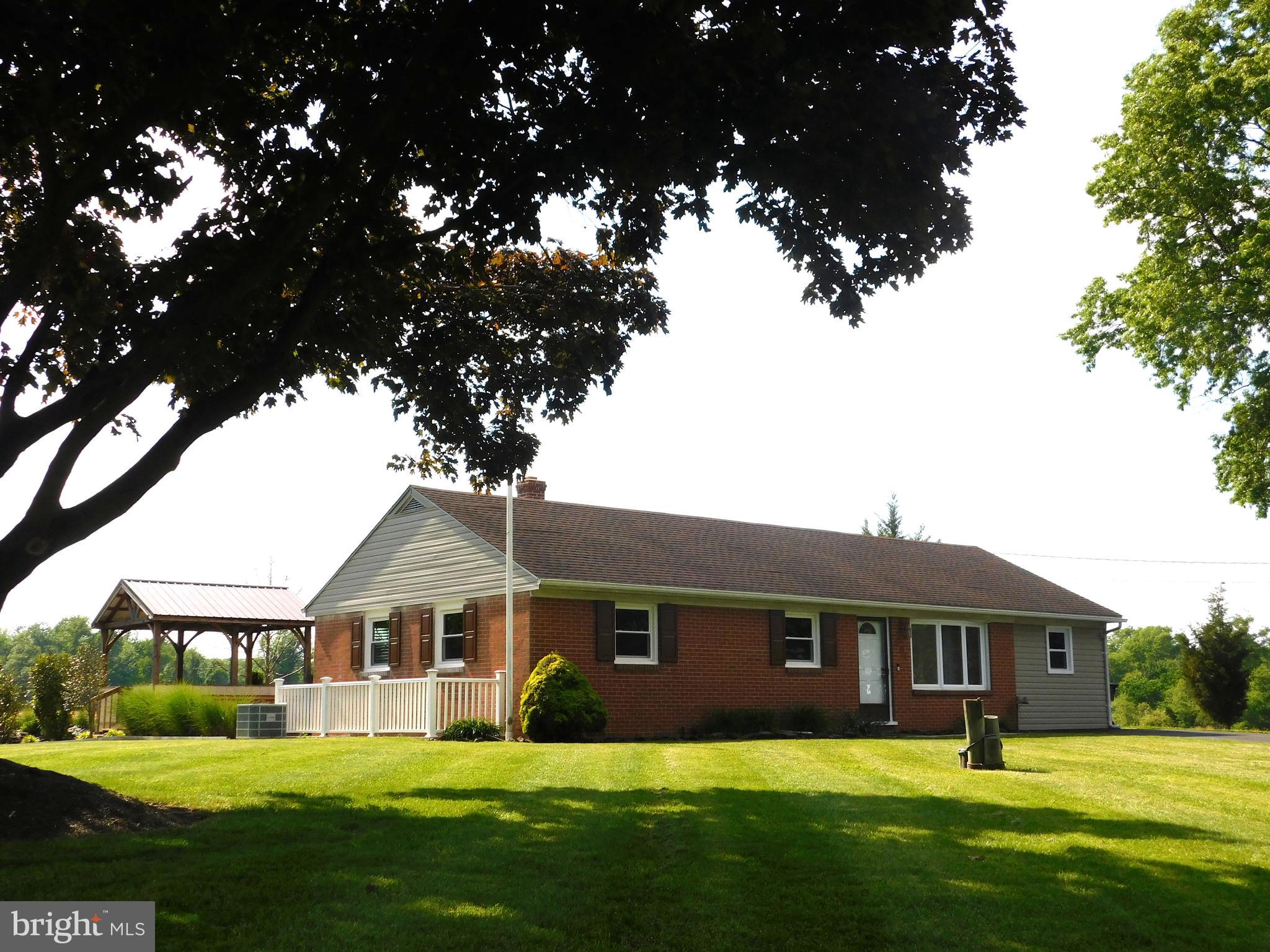 Custom built all-Brick rancher nestled among AG Preserved Farm Land.  Updates include Oil Fired Heat & CAC (2024), Pella replacement windows and doors (2024),  well pump and tank (2020), 30-year composition shingle roof (2014), and low dose pressure septic system (2011).  Hardwood floors, granite kitchen counters, stainless steel appliances.  Leaded glass lighting fixtures.  Rear stamped concrete patio with pavilion, brick fireplace,  fish pond with fountain.   Rutherford style masonry brick entry pillars. Detached 24' X 40' Garage/Shop with Atlas 8-ton 2-post lift,  Fisher wood stove, shelving, and separate storage area.  See MLS documents for detailed brochure, maps, Health Dept. records, and Seller disclosures.
