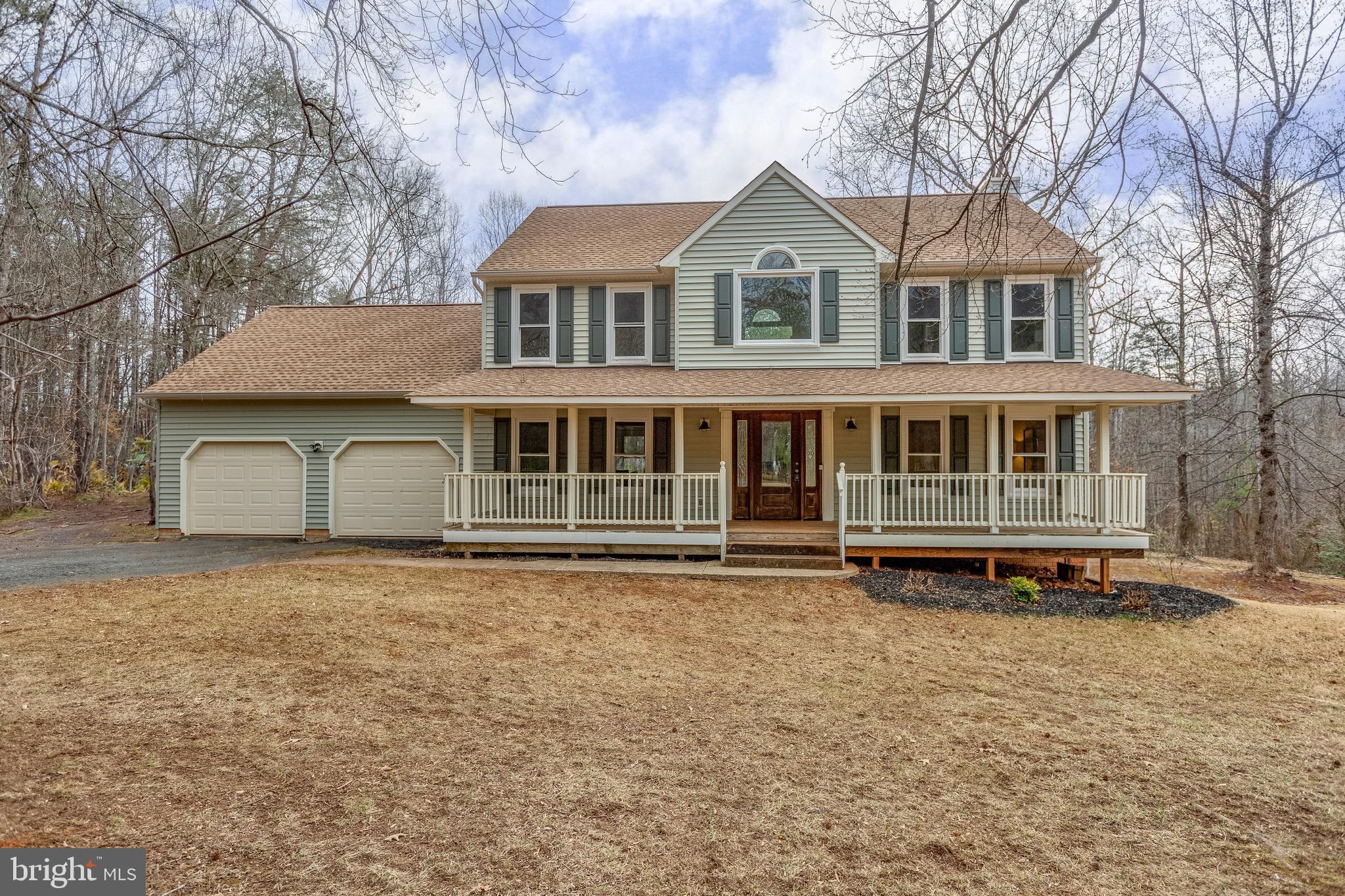 Welcome Home!  Nestled on a picturesque 1.75-acre tree-lined lot, this beautiful 4-bedroom, 2.5-bath colonial home offers the perfect blend of privacy and tranquility. Set back and located on a cul-de-sac road, this home welcomes you with an extended driveway and a charming covered front porch.  Step inside to warm-toned hardwood floors that flow seamlessly through the foyer and dining area. The spacious eat-in kitchen features a picture window that floods the space with natural light while offering backyard views. Boasting ample counter and cabinet space, a pantry, updated flooring for style and durability, and a peninsula island with additional seating, this eat-in kitchen is both functional and inviting.  The  family room, complete with a fireplace, creates the perfect setting!  Additionally, the main level includes a versatile bonus space that can serve as a den, office, formal living room, or whatever suits your needs!  Upstairs, you’ll find four generously sized bedrooms and two full bathrooms, including the Primary En-Suite.  The primary suite features a walk-in closet, while the bathroom impresses with a double vanity, a separate soaking tub, brand-new  clear enclosed shower, and stylish new flooring. The bedrooms are well-sized and include ceiling fans and spacious closets for optimal storage.  Outdoor Oasis: Enjoy both front and backyard spaces to the fullest! The expansive backyard offers open green space and a serene wooded backdrop, providing the perfect setting for outdoor enjoyment. With 1.75 acres, there’s endless potential to create your personal outdoor retreat. The extended driveway allows for ample parking, including RV parking!  Bonus Features:  Unfinished walk-out basement—a blank canvas for storage or future expansion, Fresh Paint & New Carpets, Newer Roof, Siding & Gutter Covers, MOVE-IN READY!  Don't miss this incredible opportunity to own a home that combines space, privacy, and convenience.