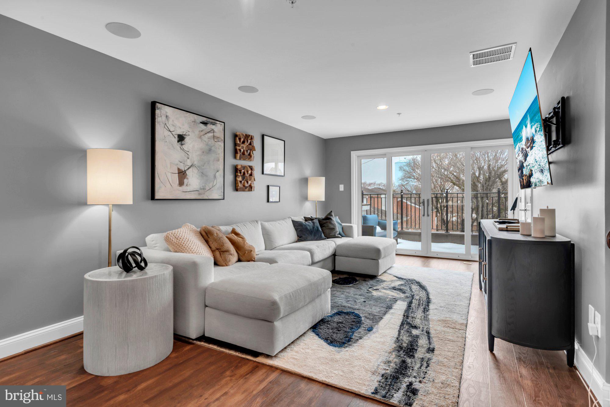 This gorgeous townhome nestled in the sought-after community of Uptown at Murray Hill, in the heart of downtown Annapolis' West Street Arts District and just steps away from restaurants, pubs, galleries and boutiques. A classic brick façade and covered front porch overlook a charming city garden. Inside, the home is professionally decorated with elegant Pottery Barn furnishings and thoughtfully curated finishes throughout. The entry level features a flex space with French doors—ideal for guests, a home office, or bedroom—along with a convenient powder room. Upstairs, the main living level showcases rich hardwood flooring and an open, light-filled layout perfect for everyday living and entertaining. The bright kitchen is a true centerpiece, complete with granite countertops, stainless steel appliances, a pantry, and a breakfast counter with seating beneath stylish pendant lighting. A sliding glass door opens to the balcony, extending your living space outdoors for grilling. The kitchen flows seamlessly into the dining area highlighted by a designer chandelier, and onward to the inviting living room with a cozy gas fireplace. The primary suite offers a peaceful retreat with luxury vinyl plank flooring, a spacious California-style walk-in closet, and a beautifully appointed ensuite bath featuring dual vanities, generous counter and cabinet space, and a glass-enclosed step-in shower with built-in bench. A large guest bedroom and a hall bath with tub/shower provide comfortable accommodations for family or visitors. The top floor adds exceptional versatility with a game room and lounge area, complete with a wet/dry bar, powder room, and direct access to a private deck—perfect for entertaining or relaxing evenings at home. Additional highlights include a garage and off-street parking. Ideally located with easy access to Rt. 50, Navy–Marine Corps Memorial Stadium, the United States Naval Academy, the Severn River, and all the shops, dining, and waterfront charm of Annapolis, this exceptional home offers the very best of Annapolis living.