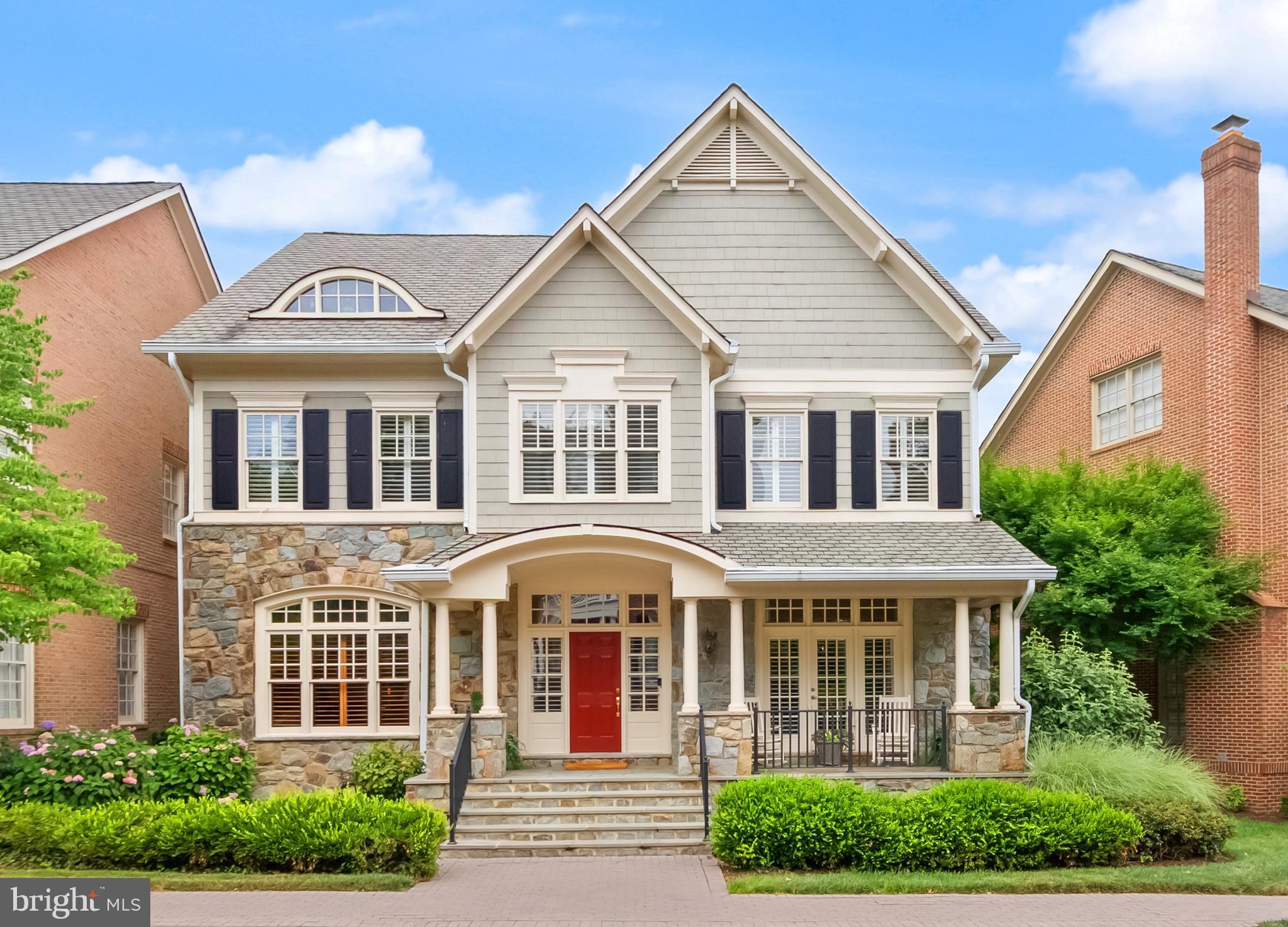 Nestled within the gated community of Evans Farm, this gracious home is surrounded by protected green space, pocket parks, brick sidewalks, and mature trees. The Nantucket-inspired exterior blends stone and shingle siding, welcoming you with a charming covered front porch and a spacious flagstone patio in the rear that overlooks the beautiful pond and historic Mill House—an idyllic setting for morning coffee, evening wine with friends, or grilling dinner on the included gas grill. Inside, four beautifully finished levels offer 5 bedrooms, 5.5 baths, and the rare convenience of elevator access to three floors. The foyer opens to a light-filled main level with 10-foot ceilings, rich hardwood floors, and deep crown molding throughout. This level features an elegant parlor, a private office with custom built-ins, a powder room, a formal living and dining room, and a stunning kitchen that flows seamlessly into the family room and casual dining area. The living room and family room both feature TVs equipped with surround sound and integrated cable management to safely bundle and conceal all cords, eliminating visual clutter for a clean and aesthetically pleasing look. The kitchen is thoughtfully designed with glass-front cabinetry accented by interior, above- and below-cabinet lighting, a Viking range, and two Thermador wall ovens—three ovens total—making it ideal for hosting gatherings large and small. Upstairs, the expansive primary suite offers a peaceful retreat with a sitting area, two walk-in closets, and a spa-like bath featuring a soaking tub, separate shower, water closet, and dual vanities. The finished attic level provides a private fifth bedroom suite with its own sitting area and ensuite bath, perfect for guests or extended stays. The lower level features a well-appointed recreation room and a TV with a built-in surround-sound system, an adjoining game area with a wet bar, a generously sized exercise room, and a full bathroom, providing a versatile and functional space for recreation and entertaining. Throughout the home, you’ll find plantation shutters, remote-controlled shades in the living and family rooms, and Lutron lighting controls. A rear-loading two-car garage is complemented by convenient guest parking just steps away, while the newly renovated Stone House serves as a vibrant gathering place for community events. Evans Farm is truly exceptional, offering both a cohesive, beautifully maintained gated environment and an unbeatable location. Just blocks from the Lewinsville Park Farmers Market and downtown McLean, minutes from Tysons Corner’s world-class shopping, and close to premier cultural venues including Capital One Hall and Wolf Trap, this home also provides easy access to Georgetown, downtown DC via the scenic GW Parkway, and both IAD and DCA airports.