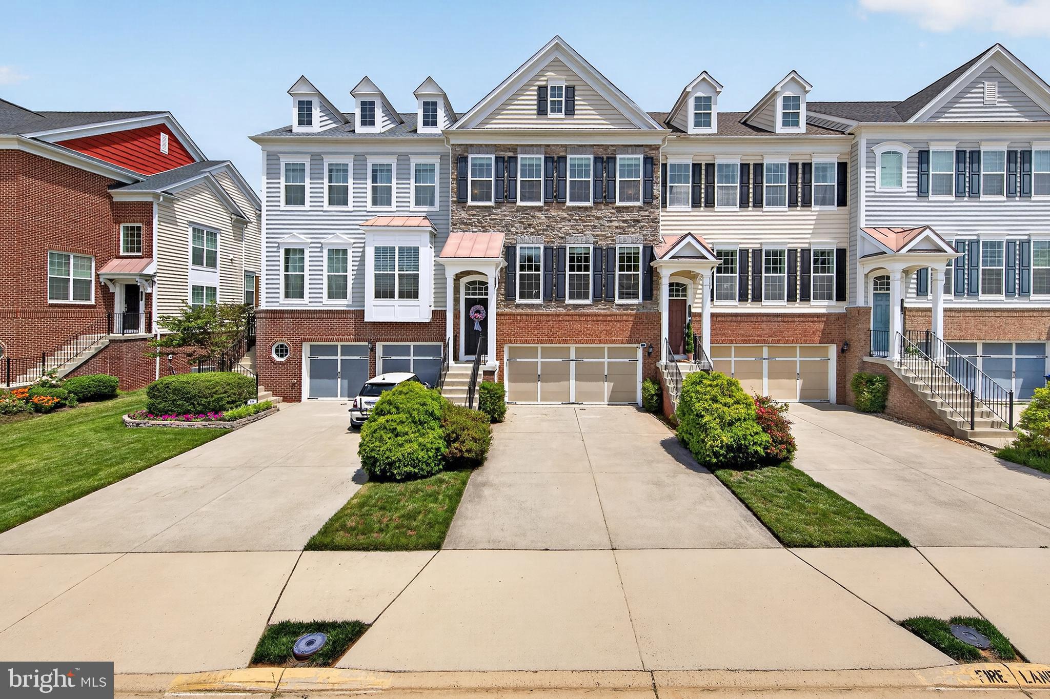 Nestled on a quiet, private street in the desirable East Gate community, this exquisite 2012 end-of-row townhouse seamlessly blends luxury and comfort. Rare for the neighborhood, a three-level bump-out significantly expands the floor plan, offering unparalleled space.

The main level features gleaming hardwood floors, elegant crown molding, a private home office, and a massive living room with a bonus sunroom/den. Culinary enthusiasts will love the gourmet eat-in kitchen, complete with stainless steel appliances, a custom pantry, and an adjacent family room. Upstairs, the luxurious primary suite boasts a tray ceiling, custom "his and her" walk-in closets, and a spa-like bath with a soaking tub and walk-in shower. Two additional well-appointed bedrooms, a full bath, and a convenient laundry room complete this level.

The fully finished lower level features a fourth bedroom, a third full bath, and a large recreation room opening to a rear patio. Premium upgrades include custom closets throughout, a custom garage floor with a separate storage room, and immediate proximity to the community pool and ample visitor parking. Commuters will love being less than 10 miles from the airport and walking distance to dining, grocery stores, and the Park & Ride (direct buses to DC, Rosslyn, Pentagon, and Crystal City). 

Experience the perfect blend of luxury, comfort, and community in this stunning townhouse, where every detail has been thoughtfully designed to create a welcoming and sophisticated living environment. Welcome home!