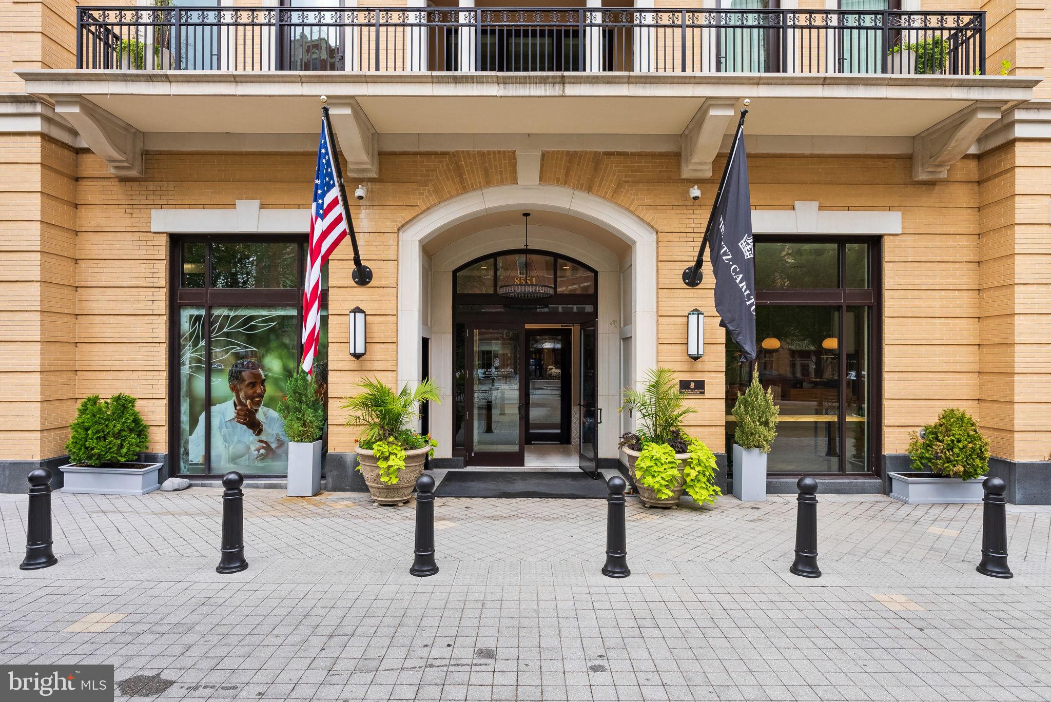 Centrally located in the Ritz Carlton Residence of Chevy Chase, this exquisite two bedroom / two full bath condominium exudes elegance with every turn. The inviting, sun-filled unit offers a seamless blend of comfort and convenience, tailored for those seeking the perfect balance of city living and relaxation. A dedicated foyer leads to the expansive open-concept living / dining room enjoying access to a private balcony with sweeping tree-top views, creating the perfect setting for entertaining and everyday living. Tray ceilings with recessed lighting, beautiful hardwood floors, and a handsome gas fireplace add to the sophistication of the space. The state-of-the-art kitchen is anchored by a stunning center island with seating, as well as elegant cabinetry and dramatic light fixtures. A highlight of this delightful residence is the primary bedroom suite, complete with a walk-in closet, an en suite spa-like bath with dual sinks, a sizable shower, and a luxurious soaking tub. There is a second bright and cheerful bedroom and a full bath. The in-unit laundry room and powder room are outfitted with gorgeous wallpaper. The Ritz Carlton Residences offer many onsite services and amenities including valet, doorman, 24/7 concierge, porter service, onsite management and building engineer, a large amenity space with a fitness center, multiple club rooms, a catering kitchen, as well as outdoor spaces with grills and fire pits. 8551 Connecticut Avenue #203 is an urban sanctuary nestled in the heart of sought-after Chevy Chase with world-renowned Ritz-Carlton standards and amenities and set atop stylish, ground-level retail, providing accessibility to shopping, restaurants, and more!