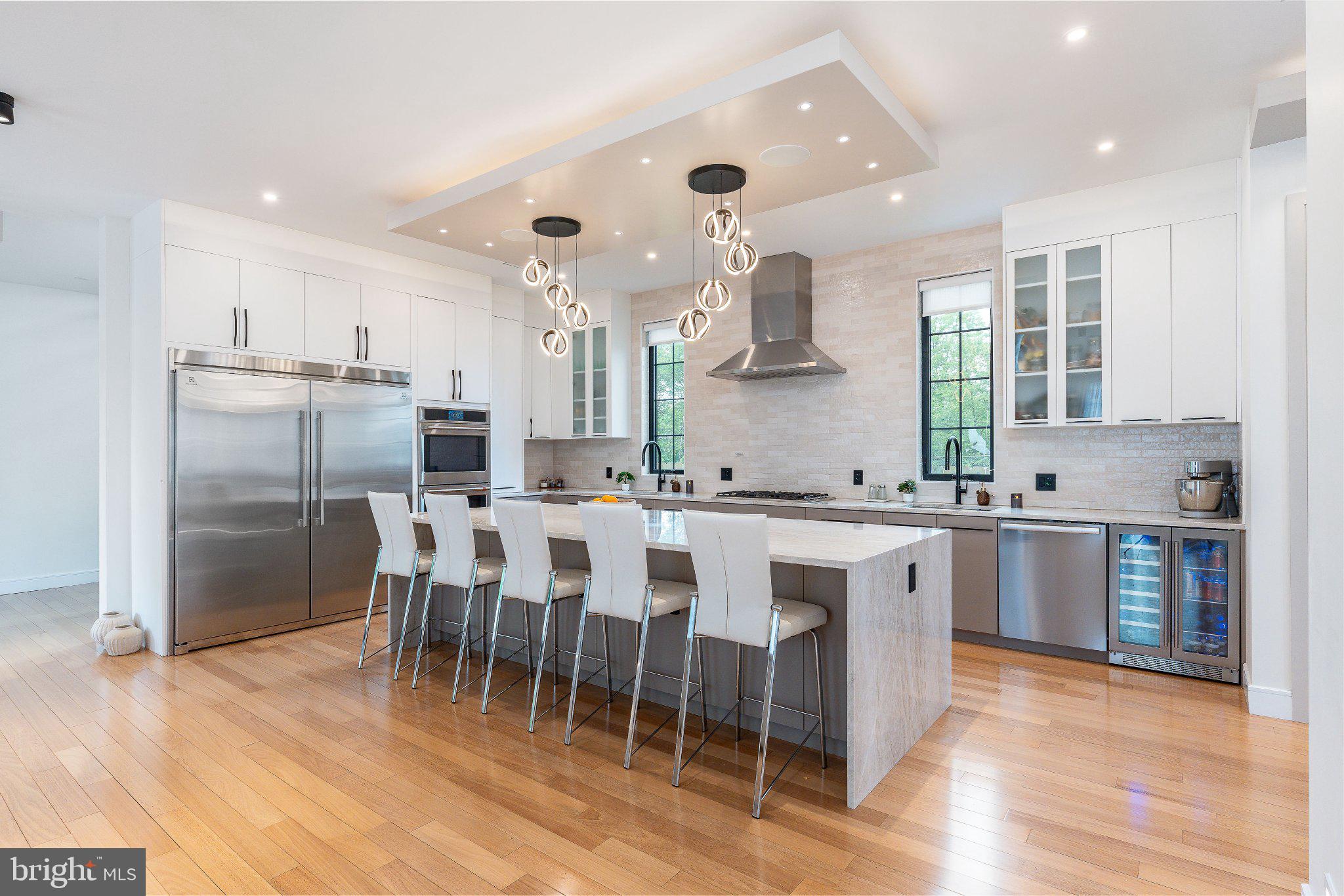 Welcome to 9739 Krewstown Road; where modern luxury meets intentional design. This is not just a home it’s the result of a vision thoughtfully brought to life over two years, crafted with purpose, precision, and a clear standard: no compromises. From the moment you step inside, the experience is immediate. Sunlight moves effortlessly through the home, illuminating rich Brazilian hardwood floors and a clean, contemporary aesthetic inspired by California living. Every finish, every material, every line was carefully selected to create a space that feels both elevated and deeply livable. At the center of it all is the kitchen—an undeniable showpiece. Outfitted with top-of-the-line stainless steel appliances, custom cabinetry, and a striking Taj Mahal quartz island, it’s the space that naturally draws people in. Guests don’t just notice it—they gather around it. It anchors the main level and effortlessly connects to multiple dining areas, from a formal dining room to a casual breakfast bar designed for everyday living.
The home was built for connection. Gatherings flow seamlessly from indoors to out, with the kitchen opening to a spacious deck that transforms into an open-air living room—perfect for entertaining, relaxing, and extending every moment just a little longer.
Upstairs, the primary suite offers a true retreat—calm, expansive, and refined. The spa-like en-suite features an oversized walk-in shower, dual vanities, and elegant marble finishes, creating a space designed for both function and escape. Four additional bedrooms continue the home’s elevated feel, each with its own en-suite bath, walk-in closet, and private balcony offering comfort and privacy at every turn. A dedicated laundry room adds convenience, while the fully finished basement redefines what additional living space can be. With 10-foot ceilings, two bedrooms, a full kitchen, full bath, and a complete entertainment setup, it becomes a world of its own ideal for guests, multi-generational living, or a private retreat. For the current owners, it became a true sanctuary the kind of space where time disappears. One of the home’s most striking architectural moments is the staircase a true centerpiece featuring Brazilian hardwood floating treads, exposed interior brick, and floor-to-ceiling windows that flood the space with natural light. It’s not just a transition between levels it’s a statement. Beyond what you can see, what truly sets this home apart is what you feel. The way light shifts throughout the day. The level of craftsmanship in even the smallest details. The intentionality behind every decision. It’s a home that reveals itself over time and once you notice it, you can’t unsee it. Step outside to a fully fenced, expansive backyard designed for both privacy and play, along with a spacious deck built for al fresco dining and effortless entertaining. The exterior blends stone and contemporary siding, complemented by professional landscaping and ample driveway parking. Perfect Saturdays here begin slowly; coffee in the kitchen as sunlight pours in; then evolve into afternoons on the deck, evenings with friends, and nights that carry on downstairs where no one is in a rush to leave. It’s a home designed around real life entertaining, relaxing, and recharging. Located in the desirable Krewstown area of Bustleton; a setting that puts dining, fitness, parks, and everyday conveniences within easy reach, the lifestyle here extends well beyond the walls of the home. With 9 years remaining on the tax abatement, this property also offers meaningful long-term savings adding financial value to its already exceptional design and livability. This home is for someone who wants it all a space warm enough to grow into, yet refined enough to feel like a private retreat. A home for those who appreciate design, value experience, and refuse to compromise. This is more than a home. It’s a lifestyle by design.

Schedule your showing today.