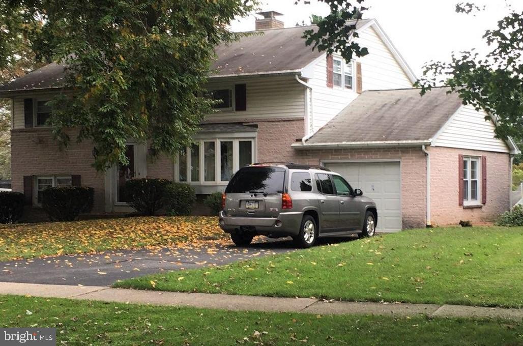 Classic multi level split w/hardwood flooring offers living room entry, lower level kitchen, dining room w/sliders to enclosed porch, separate laundry room w/garage access, and 4 upper level bedrooms and 2 baths.  Additionally, there is a basement for additional storage.