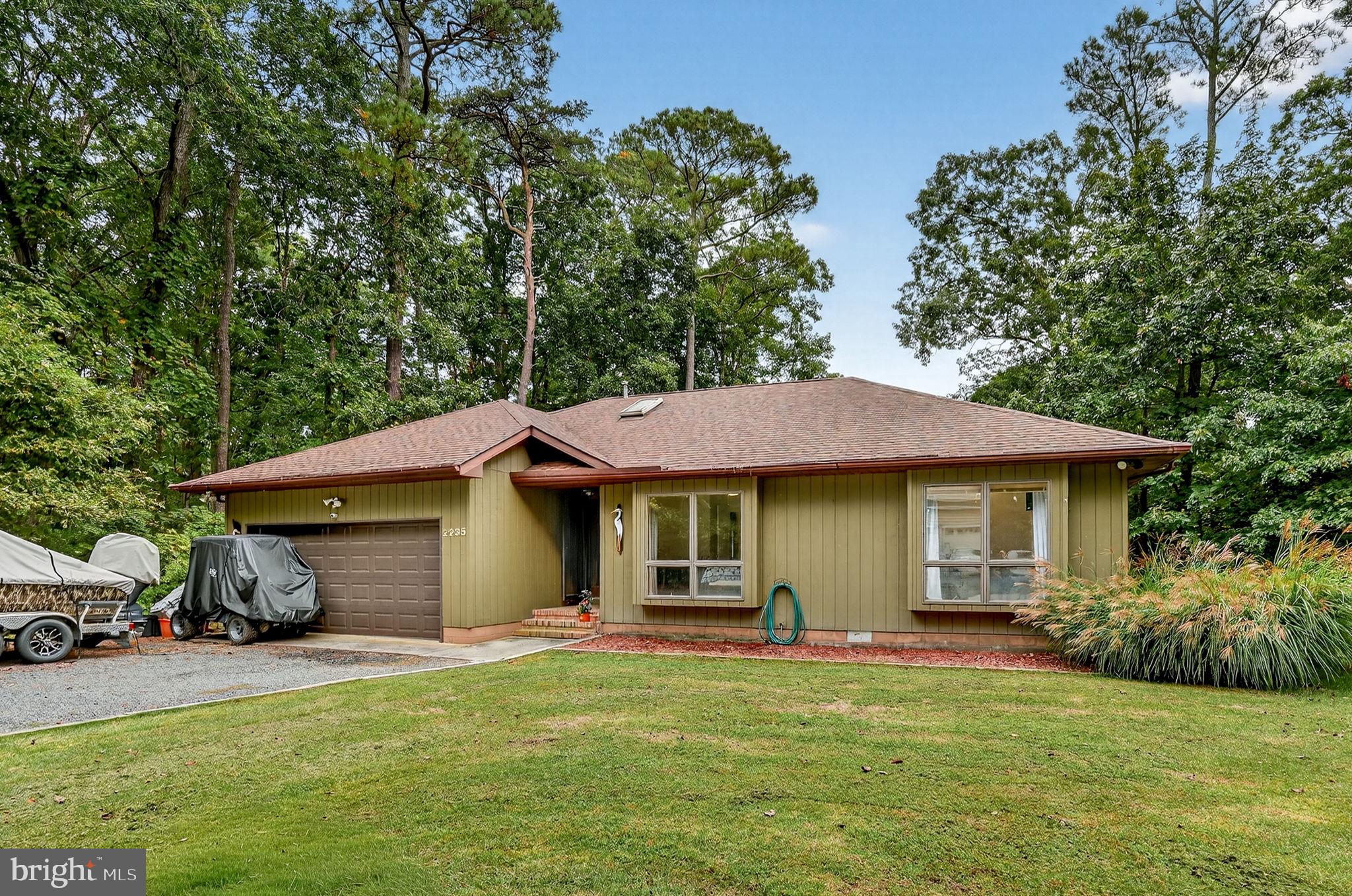TWO LOTS INCLUDED! Beautifully remodeled contemporary ranch nestled on two spacious wooded lots in the desirable Captain’s Cove community. This inviting home offers the perfect blend of modern updates, comfortable one-level living, and peaceful natural surroundings. Step inside to a welcoming tile foyer that opens into a spacious living room featuring vaulted ceilings, a cozy gas fireplace, and attractive LVP flooring. The dining area flows easily from the main living space, creating a comfortable layout for everyday living and entertaining. The updated kitchen offers granite countertops, stylish finishes, and functional workspace, with a convenient laundry area nearby. The primary suite provides a relaxing retreat with a vaulted ceiling and renovated private bath, while two additional bedrooms and an updated full bath offer space for guests, family, or a home office. Enjoy the outdoors from the screened-in back porch or adjoining deck, ideal for morning coffee, evening relaxation, grilling, or watching the abundant wildlife. The property also includes an outdoor shed for added storage, plus a 2-car attached garage with built-in workbench and pull-down access to a floored attic for even more storage and workspace. Major system update: new HVAC installed in February 2025. Surrounded by the natural beauty and amenities of Captain’s Cove, this move-in ready home offers comfort, privacy, and the Eastern Shore lifestyle all in one.