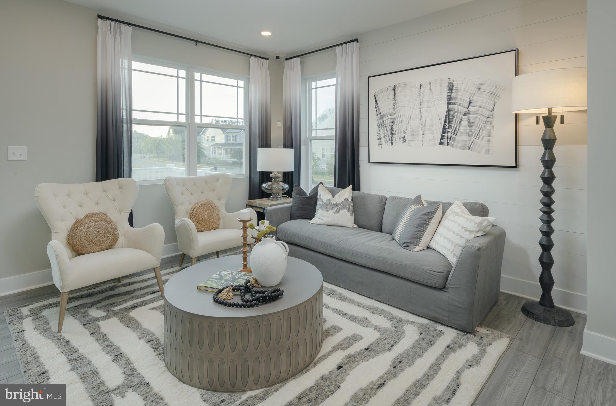 Welcome to 1801 Betterton Road in the Water’s Landing community of Essex. This stunning end-of-row townhome, built in 2023, offers over 2,400 square feet of modern living space with 3 bedrooms, 2 full baths, and 2 half baths. Previously used as the community’s model home, it showcases upgraded finishes and enhanced decorative features throughout and has never been lived in. The open-concept layout features a spacious kitchen with an island, stainless steel appliances, upgraded countertops, and recessed lighting that flows seamlessly into the dining and living areas. The upper level includes three bedrooms, including a spacious primary suite with walk-in closets and a private bath. Additional highlights include a one-car front-entry garage, driveway parking, and low-maintenance living in a well-located Baltimore County community.