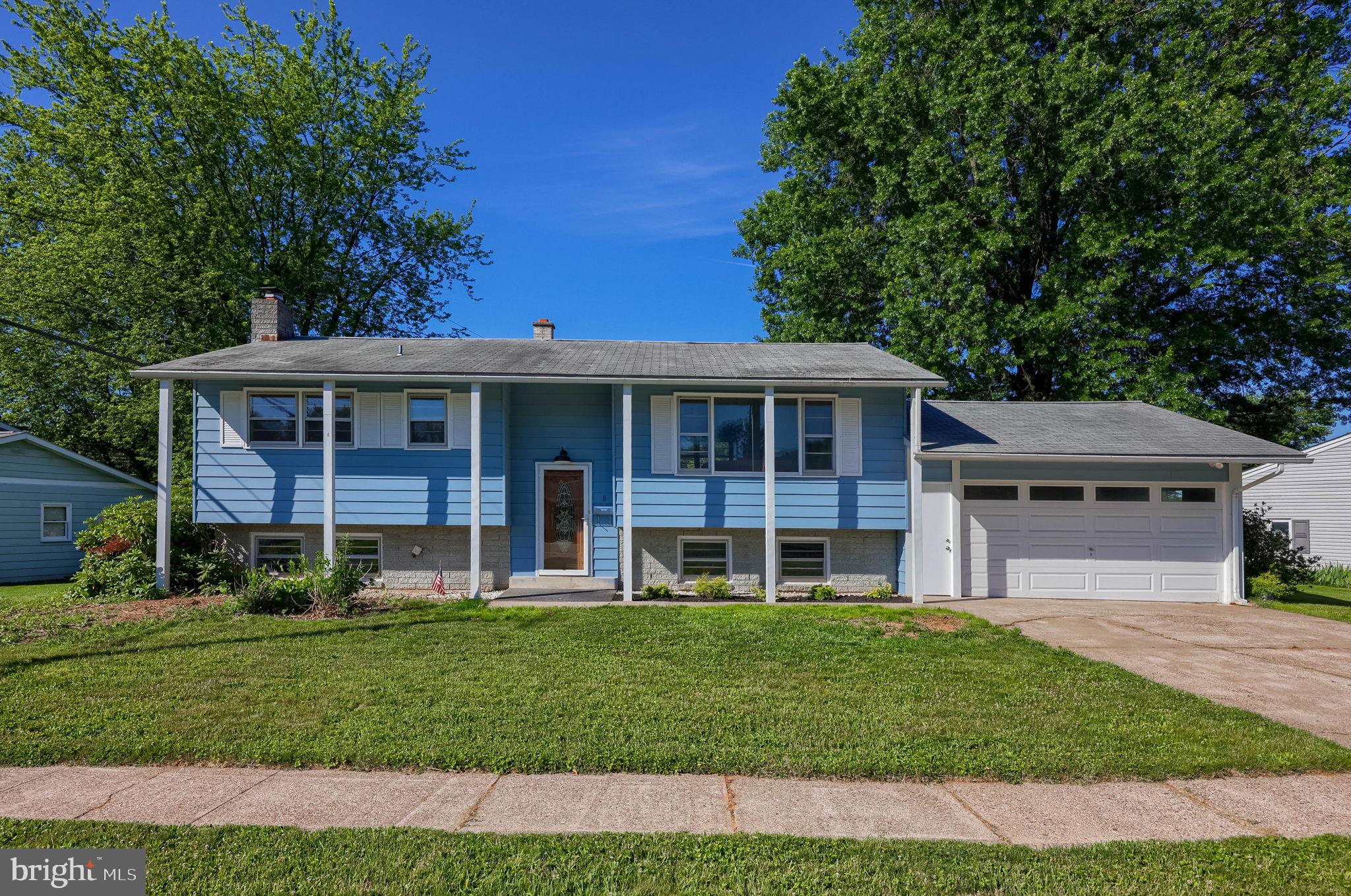 Welcome home to this beautifully maintained split-level residence, offering four bedrooms, two full bathrooms, and thoughtful updates throughout. The main level features gleaming hardwood flooring, a bright and inviting living room, and an updated kitchen with granite countertops, tile backsplash, stainless steel appliances, and custom cabinetry. Upstairs, you will find three comfortable bedrooms and an updated full bathroom, with generous closet storage and plenty of natural light in each room. The finished lower level adds valuable living space with an additional bedroom, full bathroom, cozy fireplace, and flexible areas for a family room, guest space, home office, playroom, or fitness area. A dedicated laundry room with cabinetry provides added convenience and storage. Outside, the flat fenced backyard offers a wonderful setting for relaxing, entertaining, gardening, or everyday outdoor enjoyment. The two-car garage includes a dedicated storage area, while the shed with electricity adds even more functionality for tools, lawn equipment, hobbies, or seasonal items. Additional highlights include central air, forced-air heating with gas baseboard backup, tasteful updates, abundant storage, and a comfortable layout designed for everyday living. Schedule your tour today!